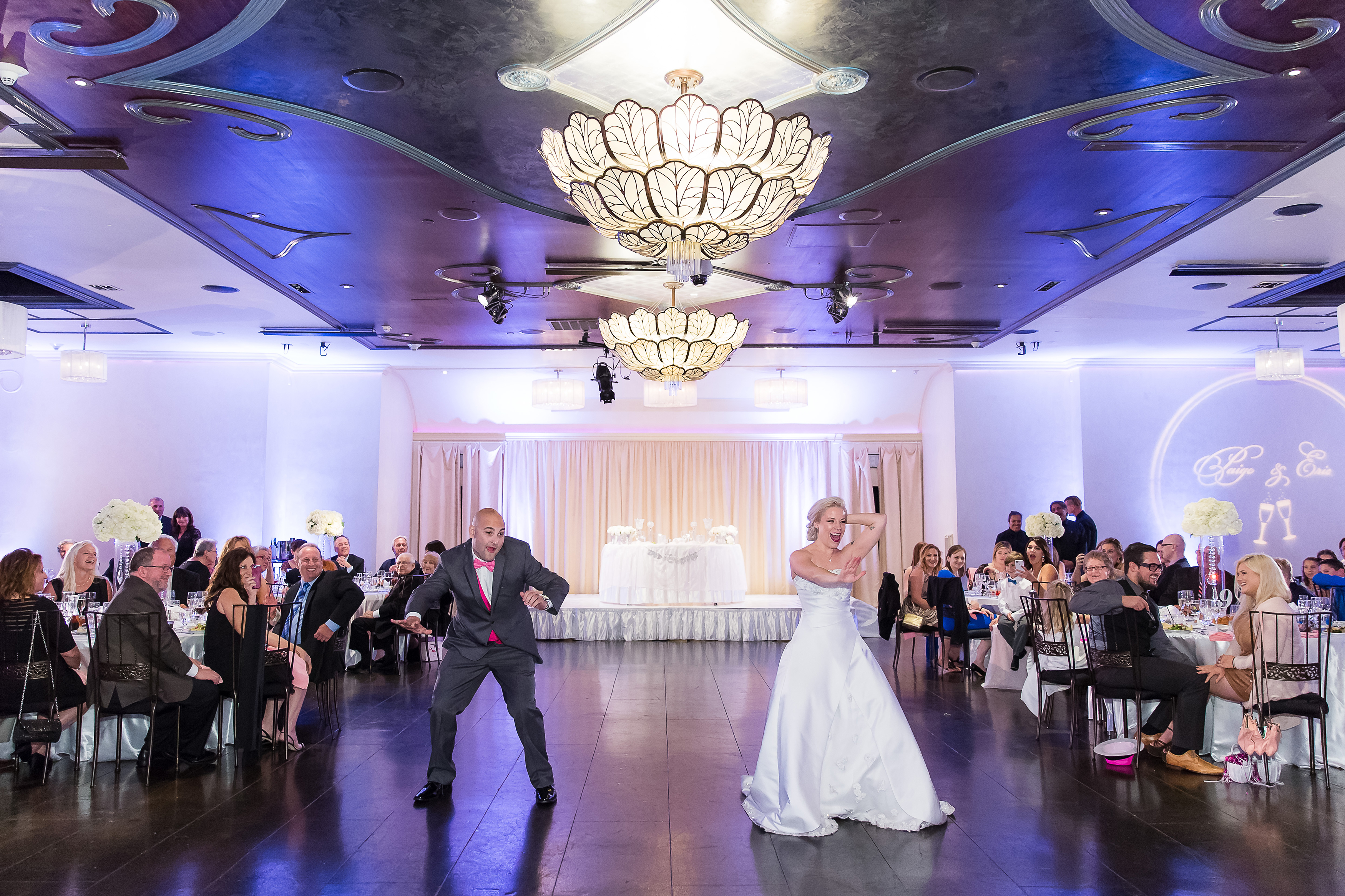 Bride and groom dancing funny during wedding reception in hall at Noor in Pasadena, CA