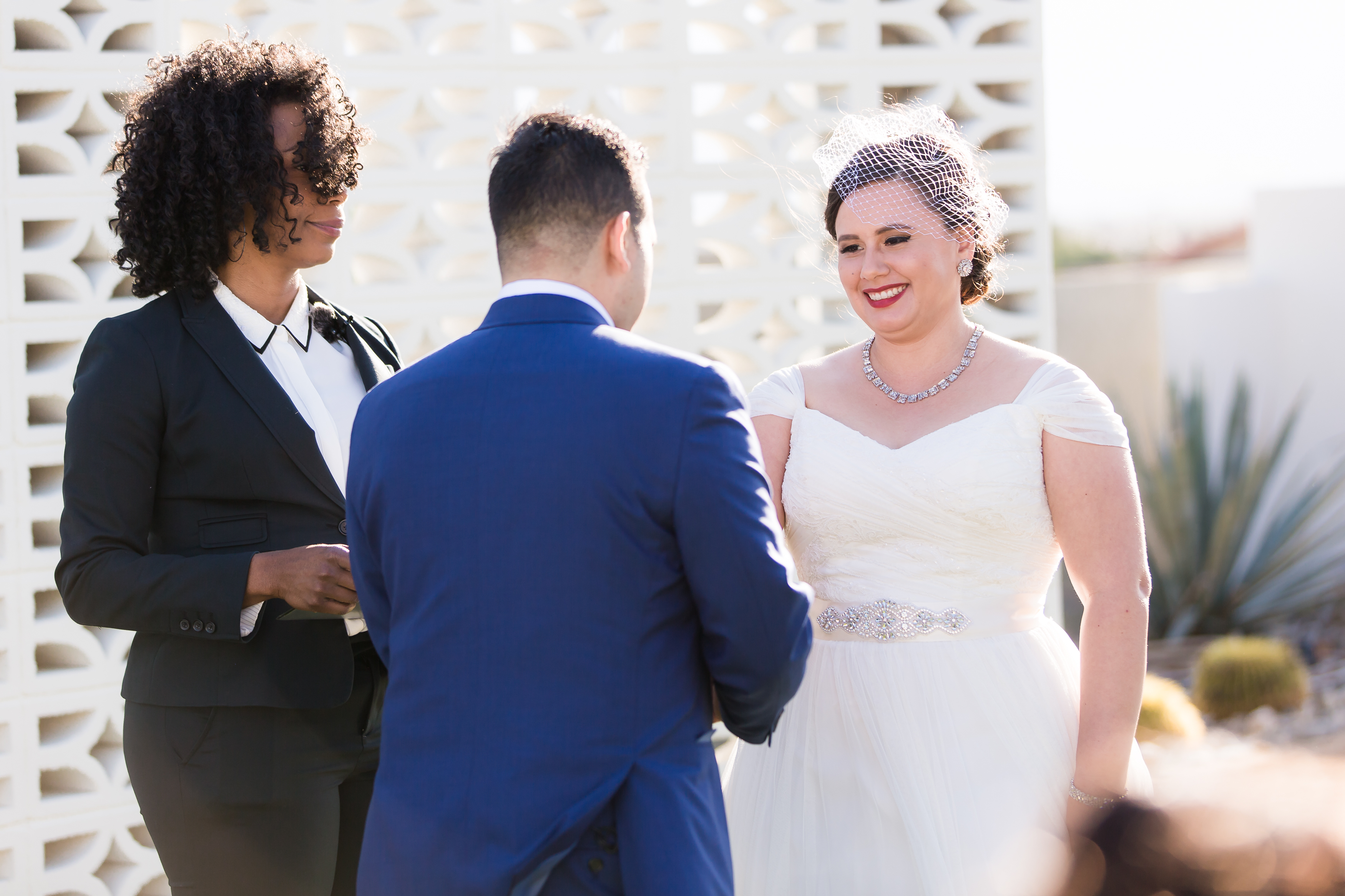 Bride smiling at groom during outdoor wedding ceremony 