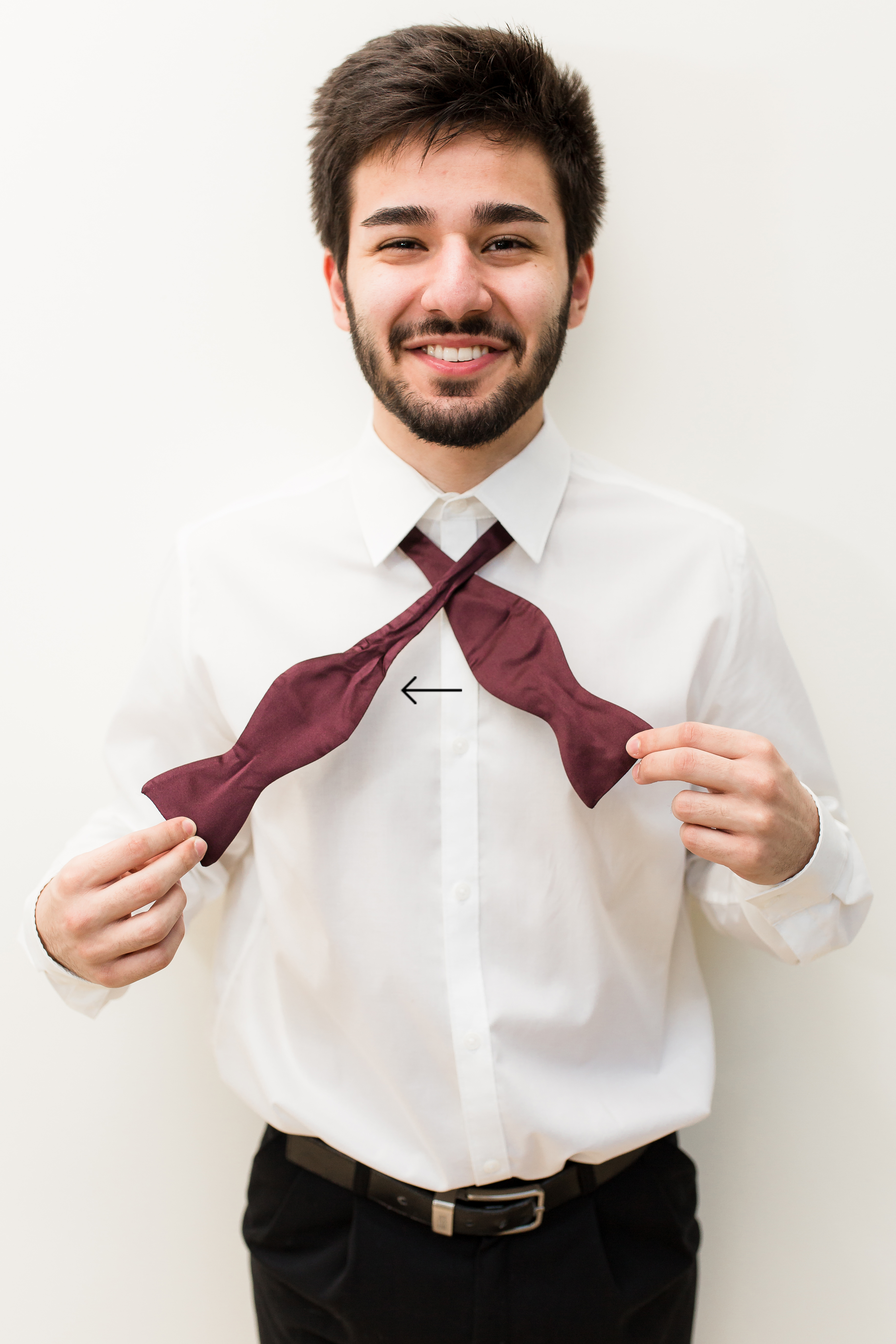Man crossing over burgundy bow tie