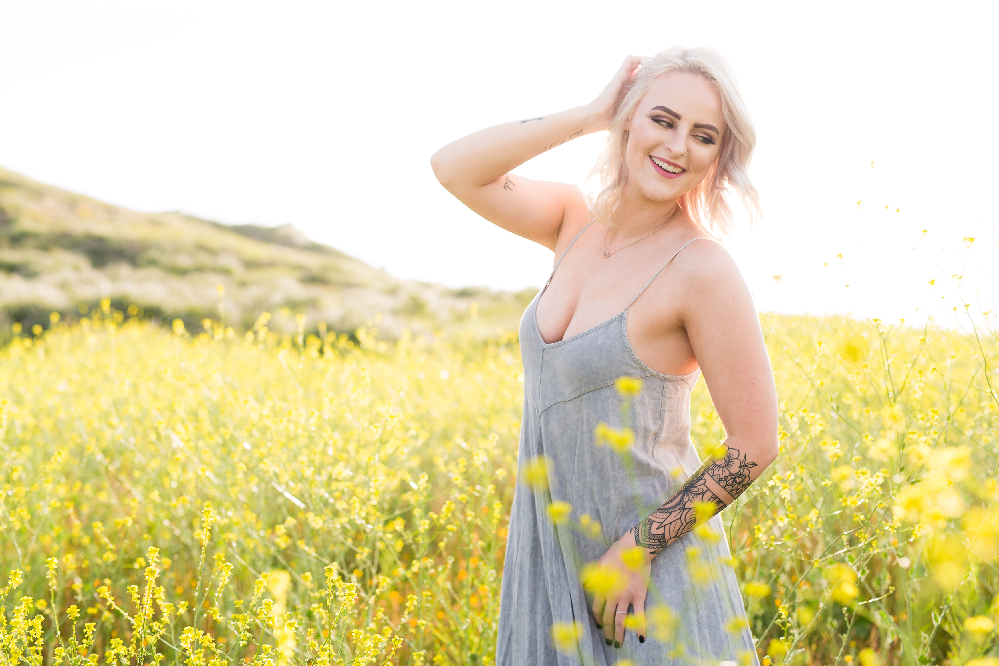Girl smiling in field of yellow poppies