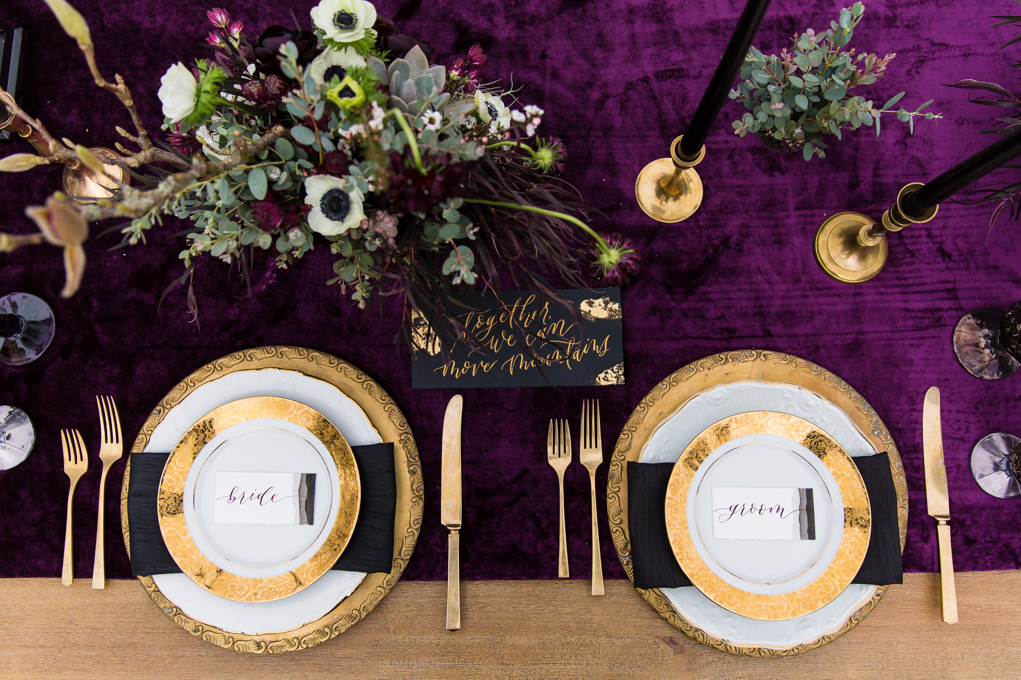 Purple sweetheart table with gold plates and black accents
