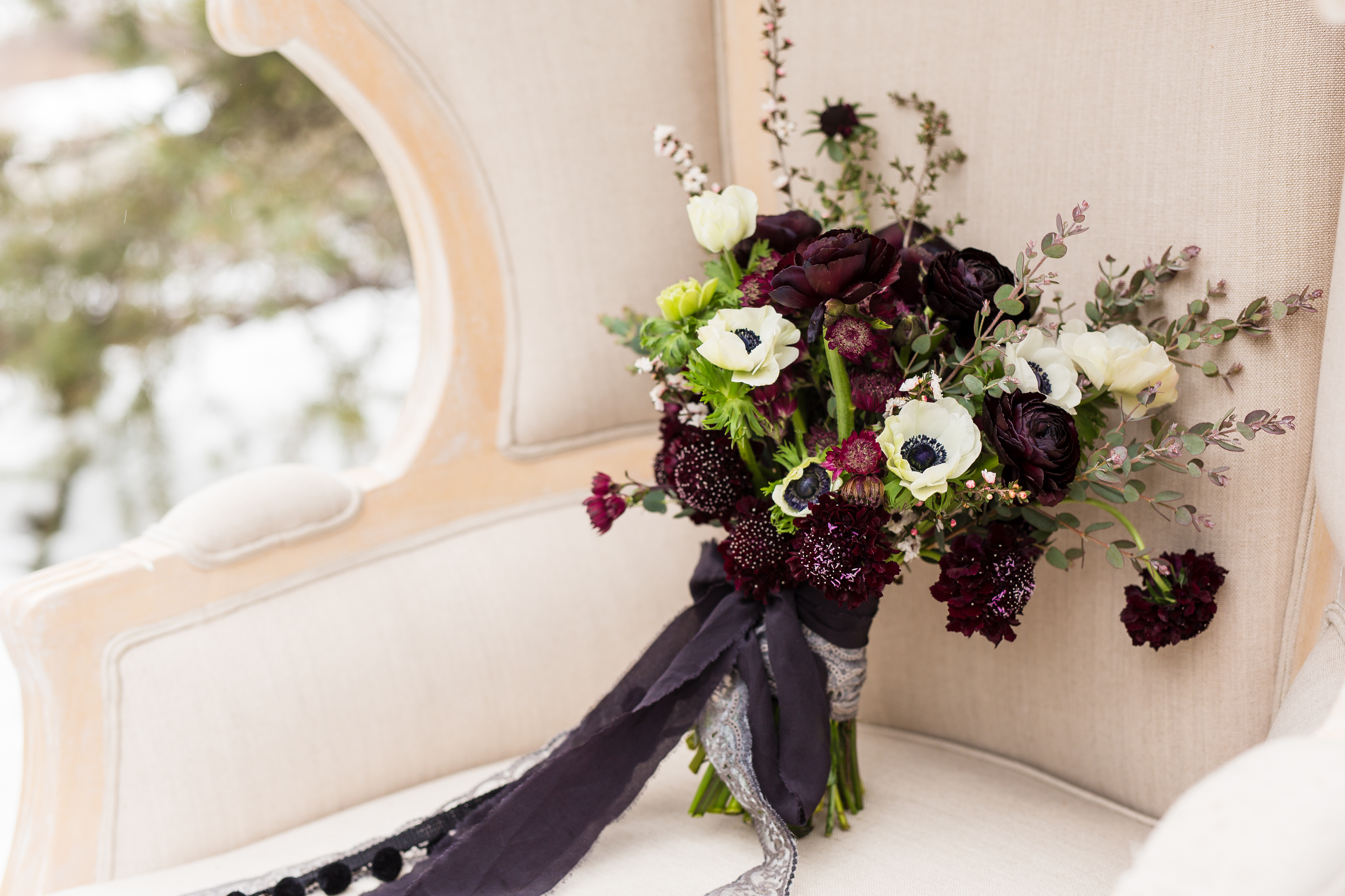 Moody themed wedding bouquet with black and silver ribbon