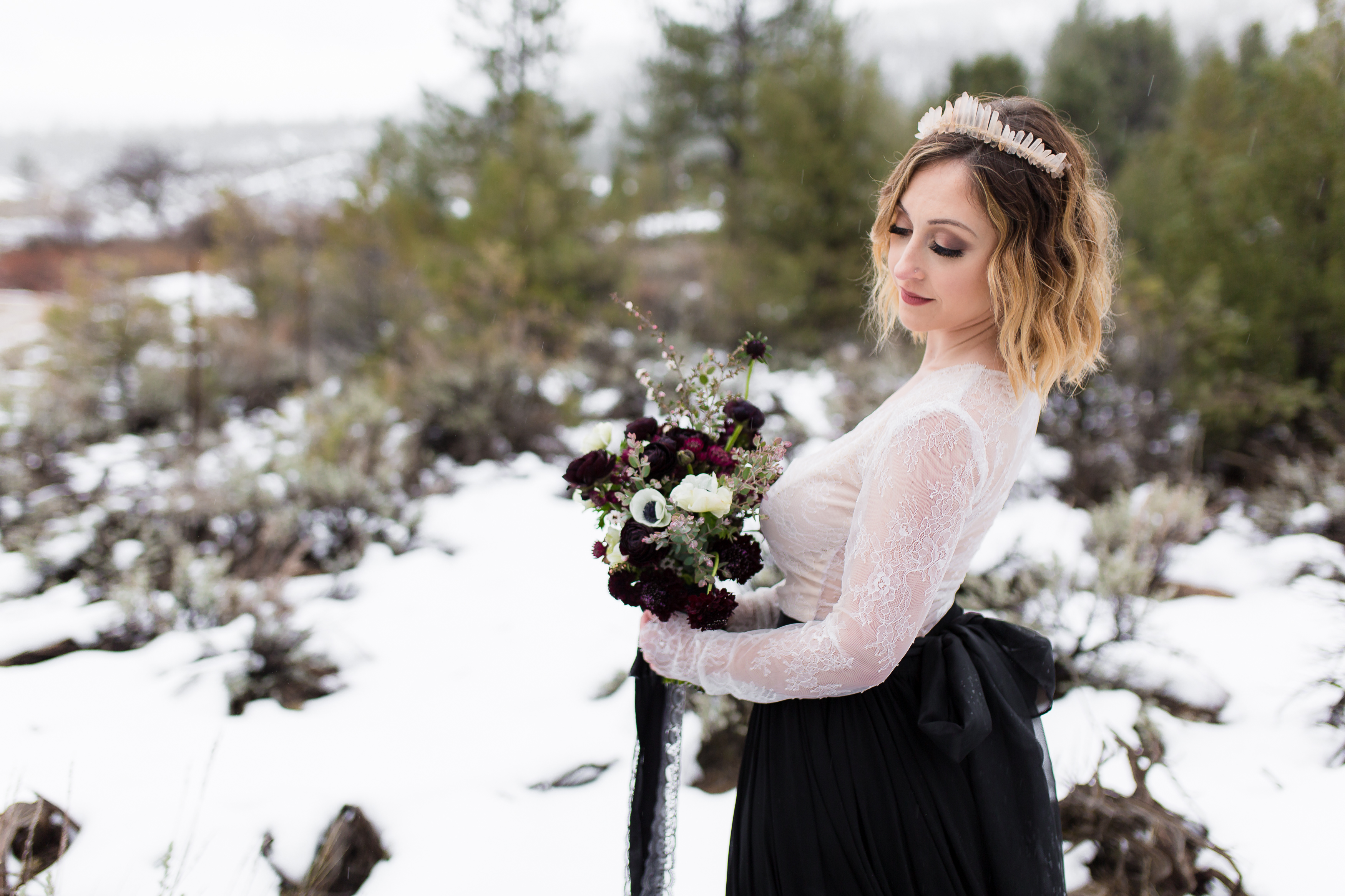 Bride in two piece wedding dress and quartz crown in snow, by Stefani Ciotti