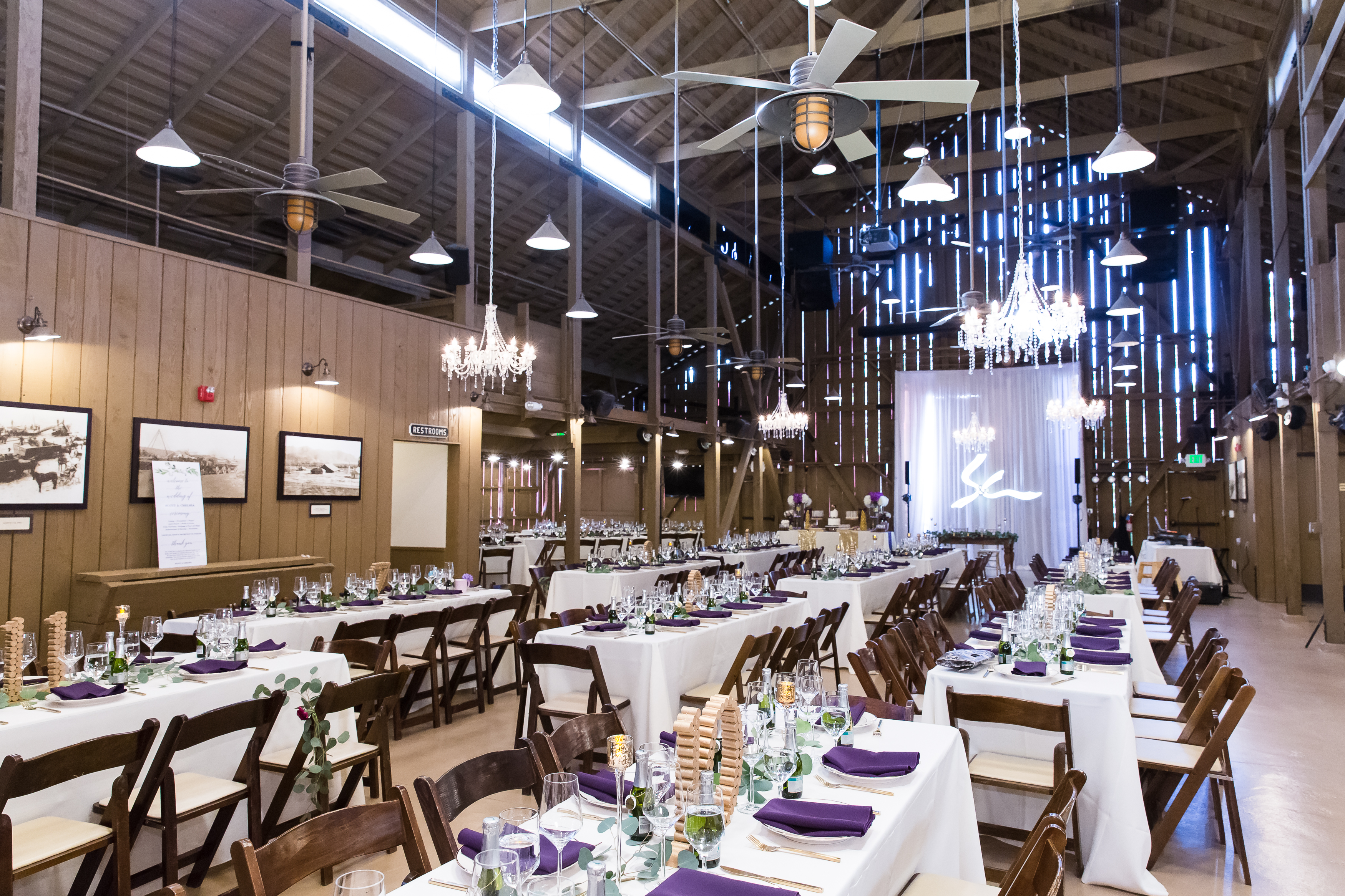 Wedding reception with chandeliers and wooden walls and ceilings