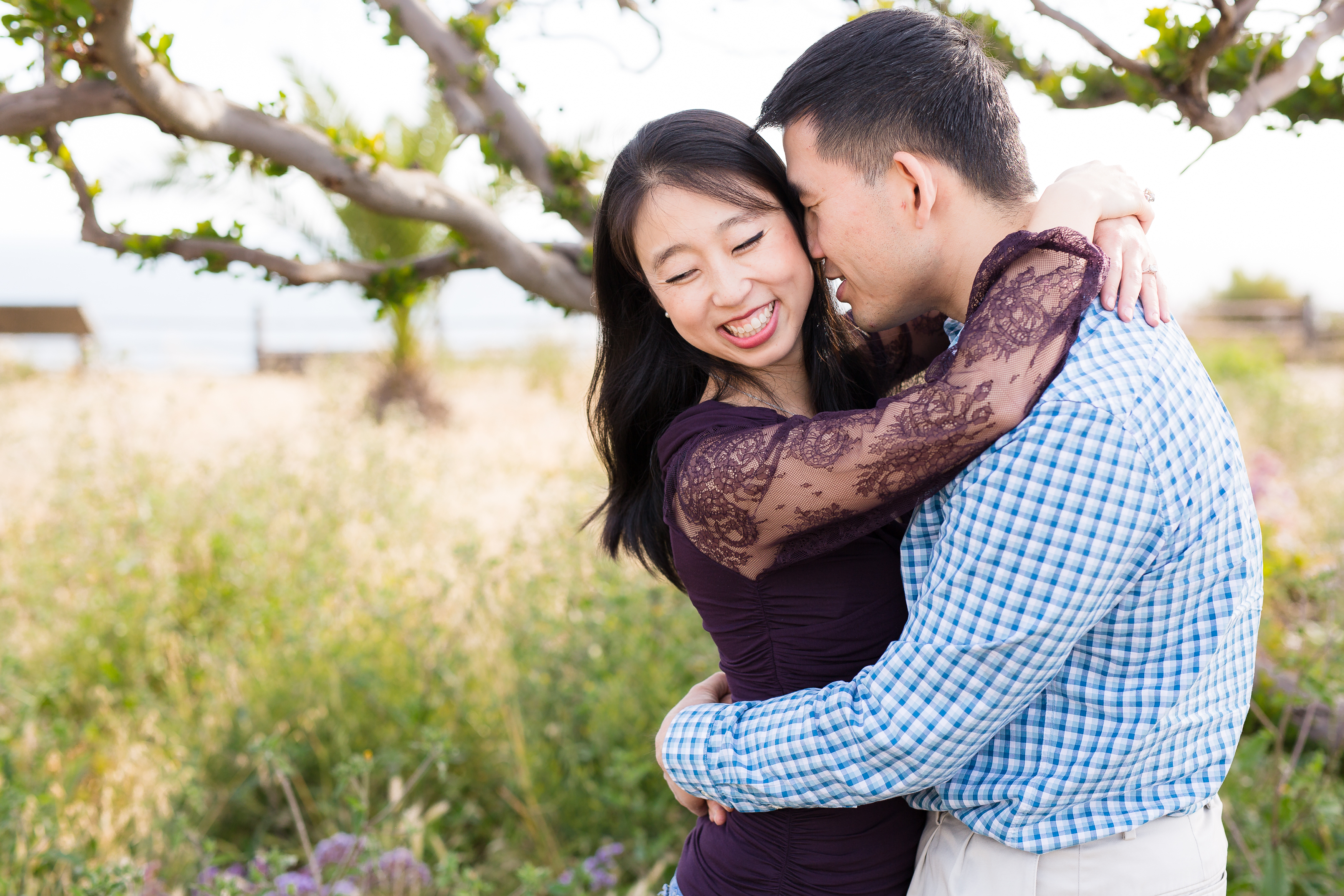 Asian couple hugging during their Point Vicente Lighthouse Engagement