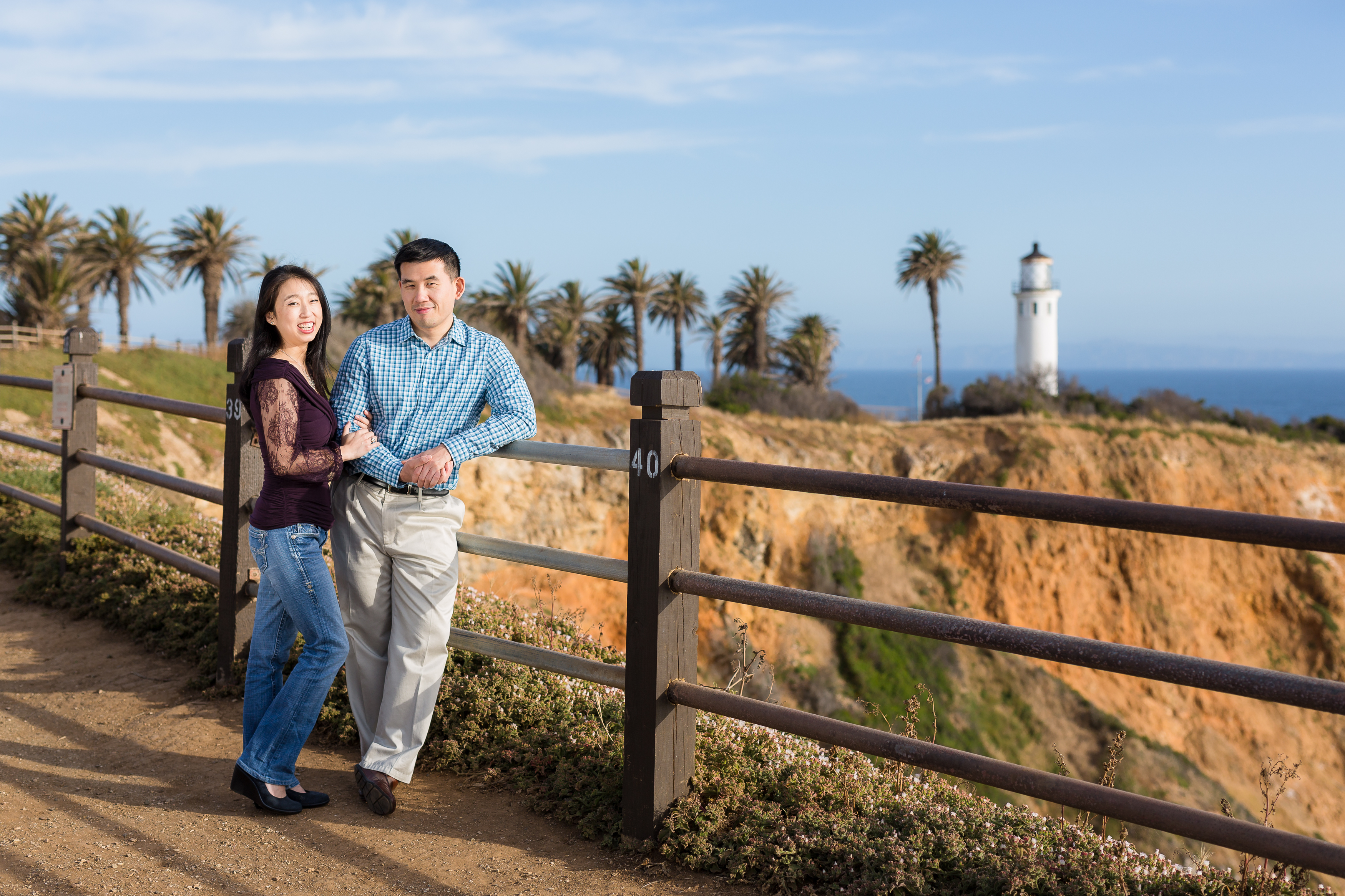 Cute couple leaning against fence near the Point Vicente Lighthouse