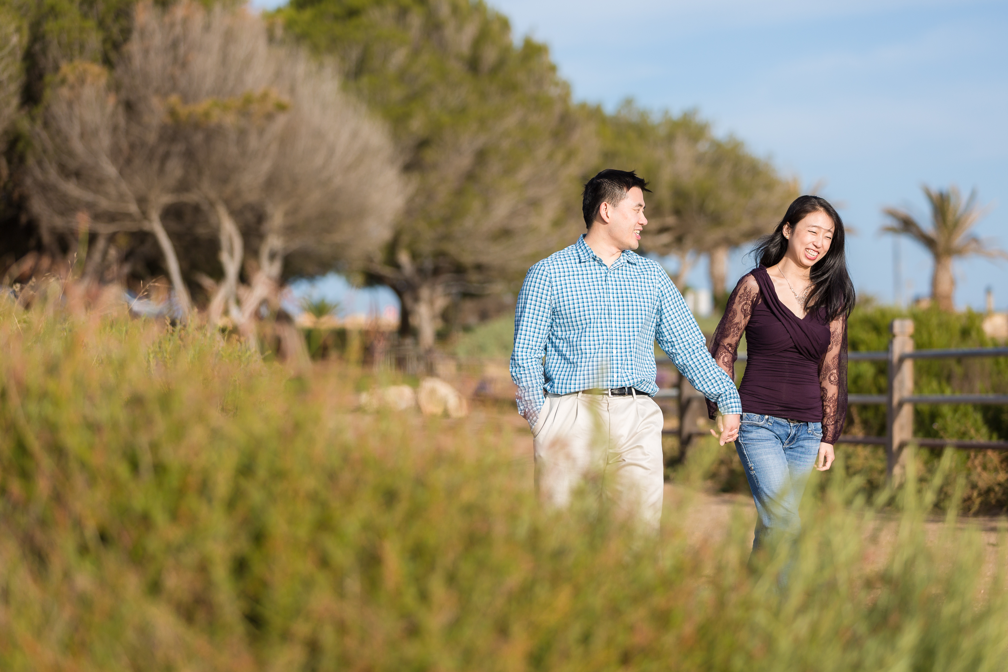 Sweet engaged couple walking hand in hand in Palos Verdes by Stefani Ciotti