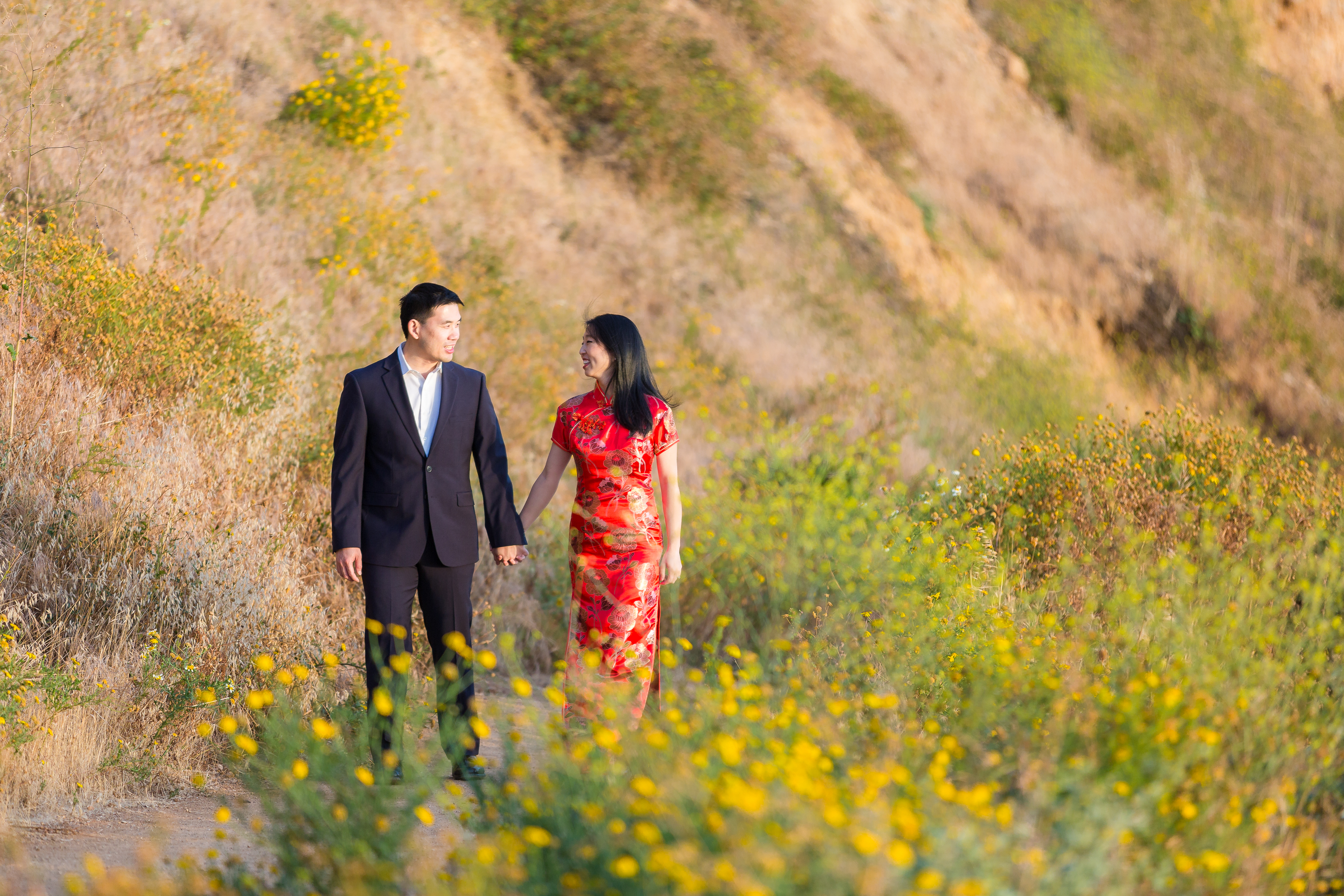Couple holding hands during engagement session on Palos Verdes pathway