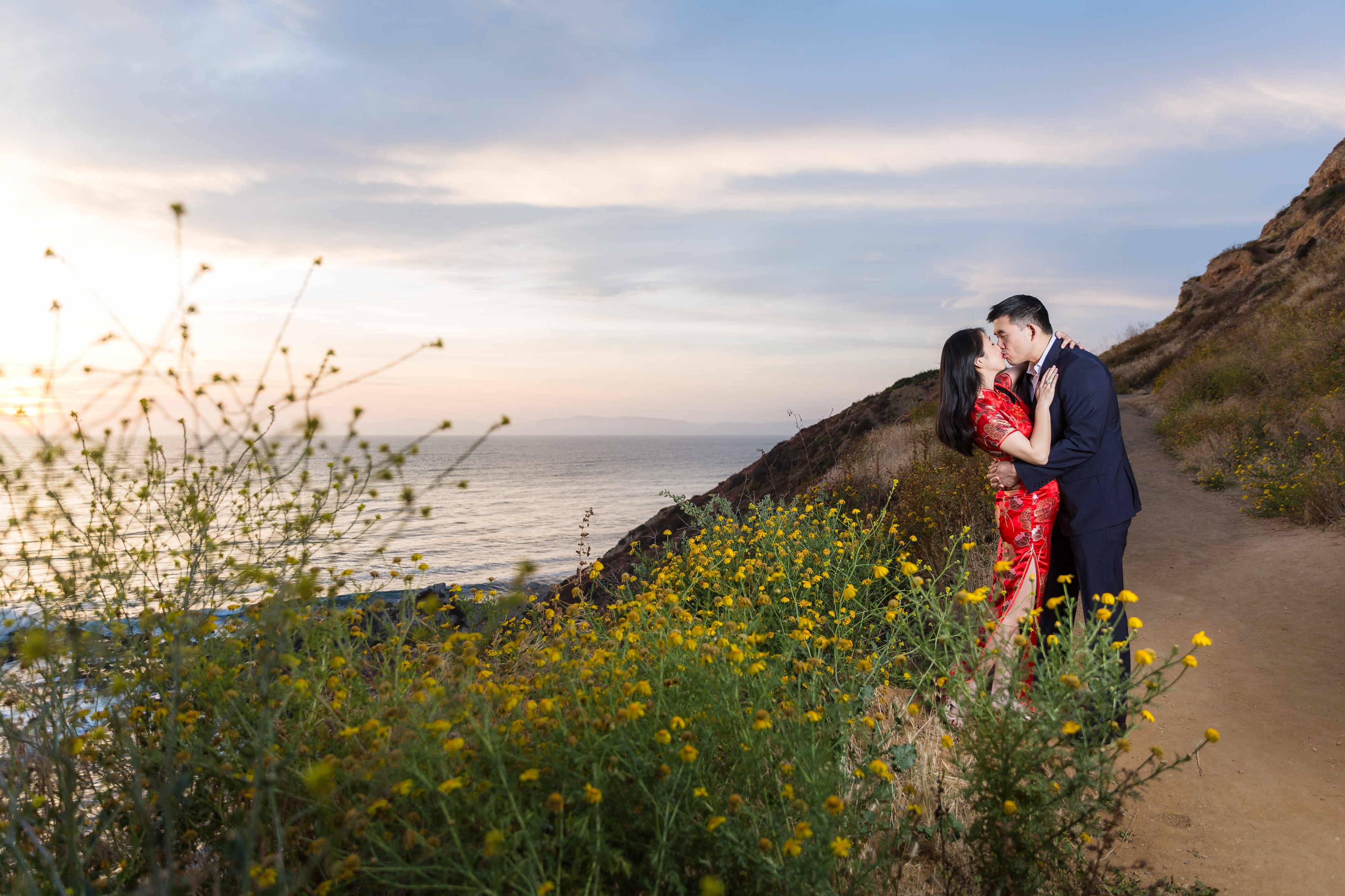 Asian couple dipping and kissing on cliffside, photographed by Stefani Ciotti