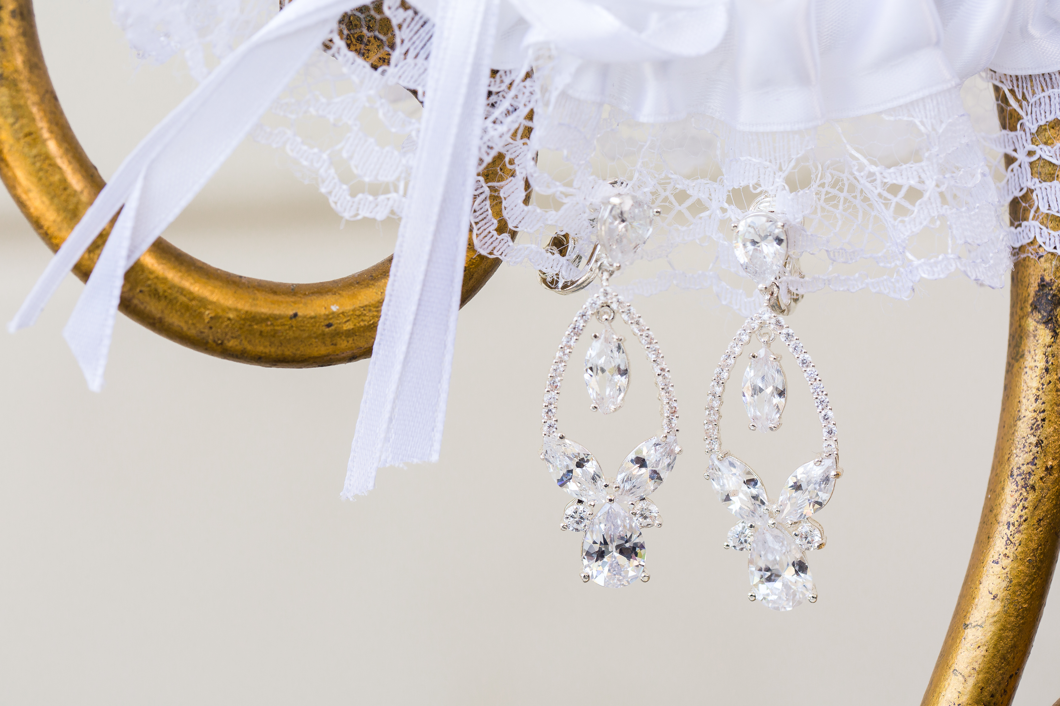Bride's diamond earrings hanging from garter