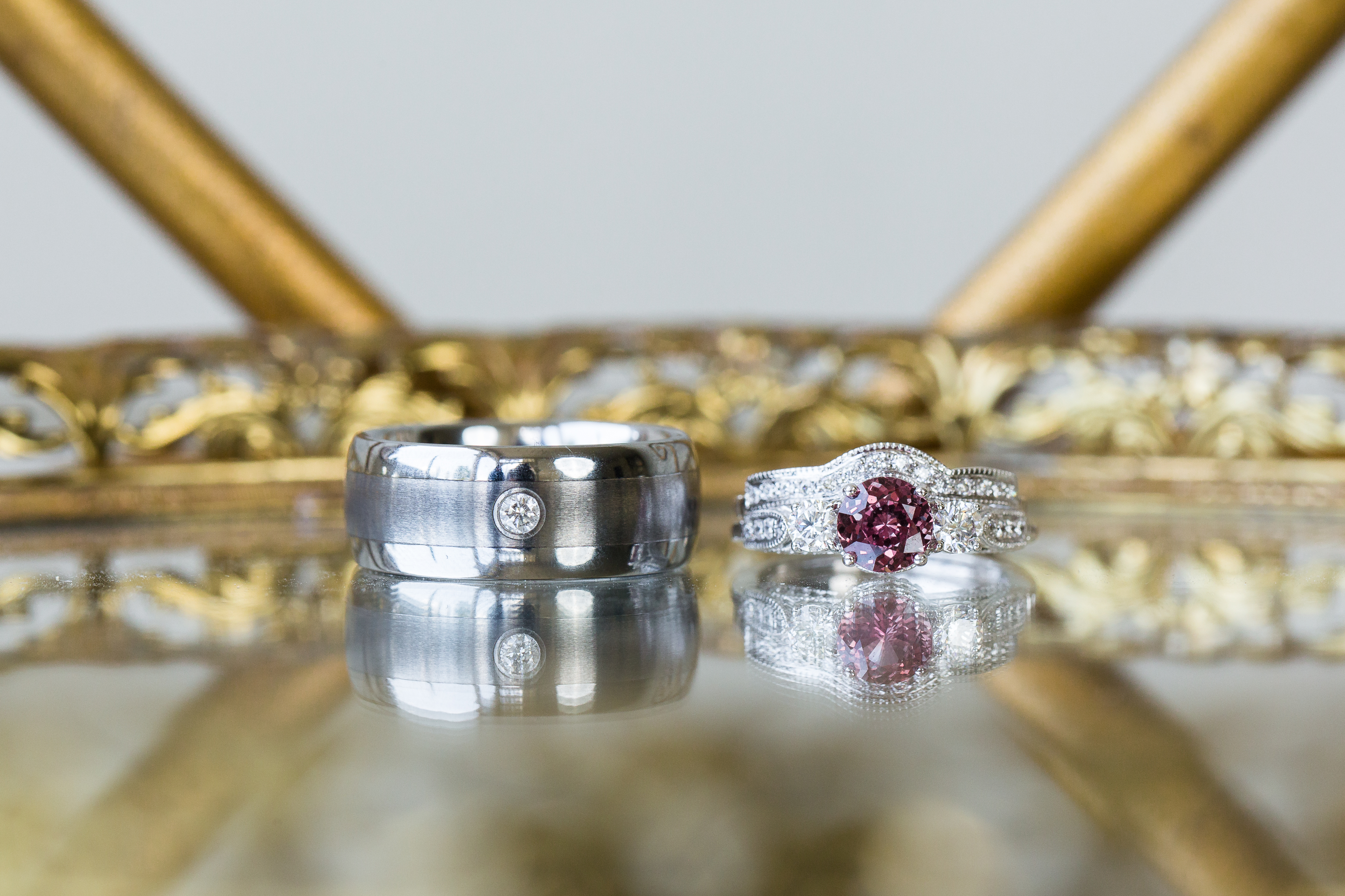 Bride's ruby and diamond ring and groom's diamond and silver wedding ring