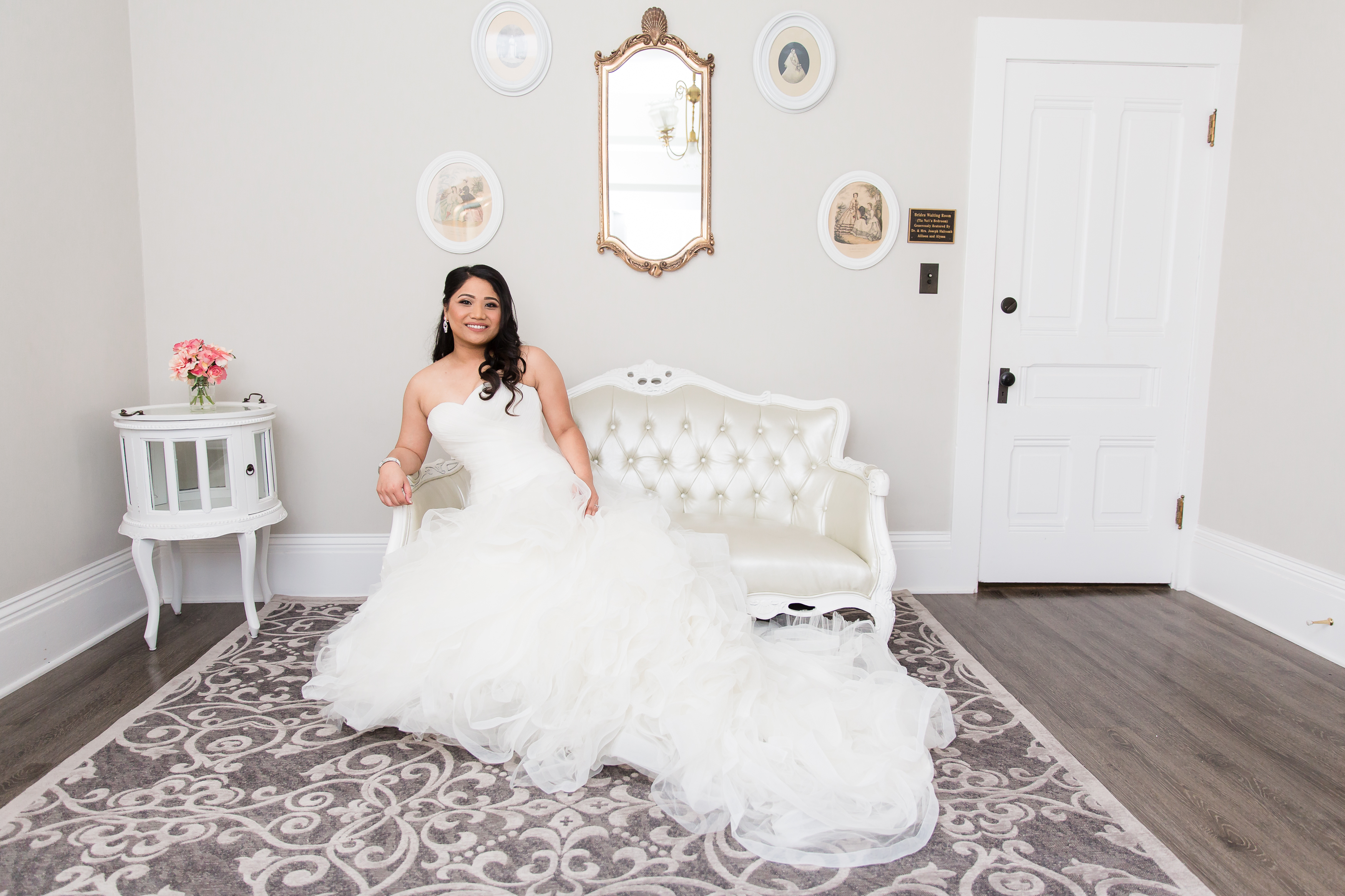 Bride sitting on couch in bridal suite at Camarillo Ranch House