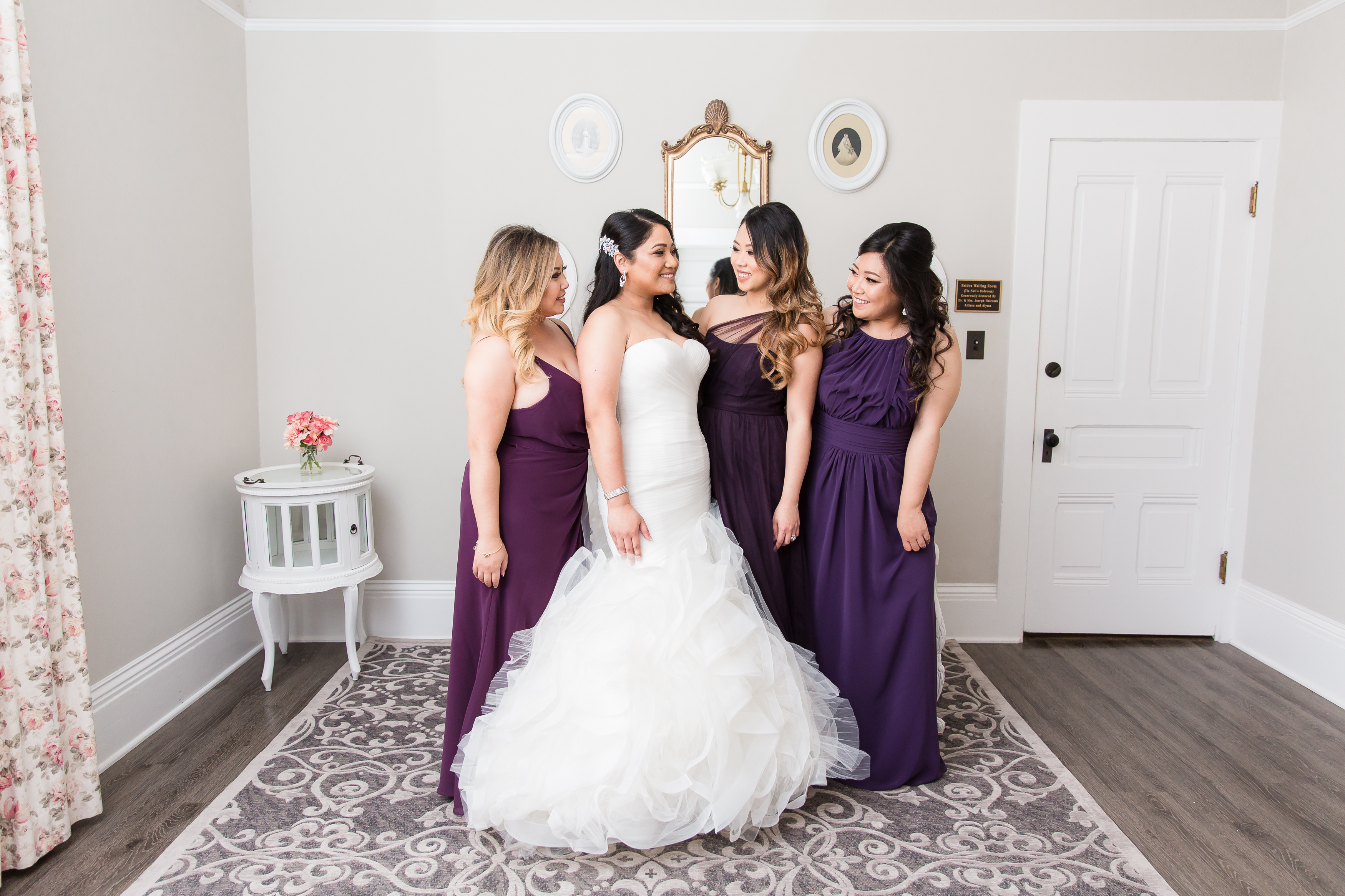 Bridal party smiling at each other in bridal suite in Camarillo