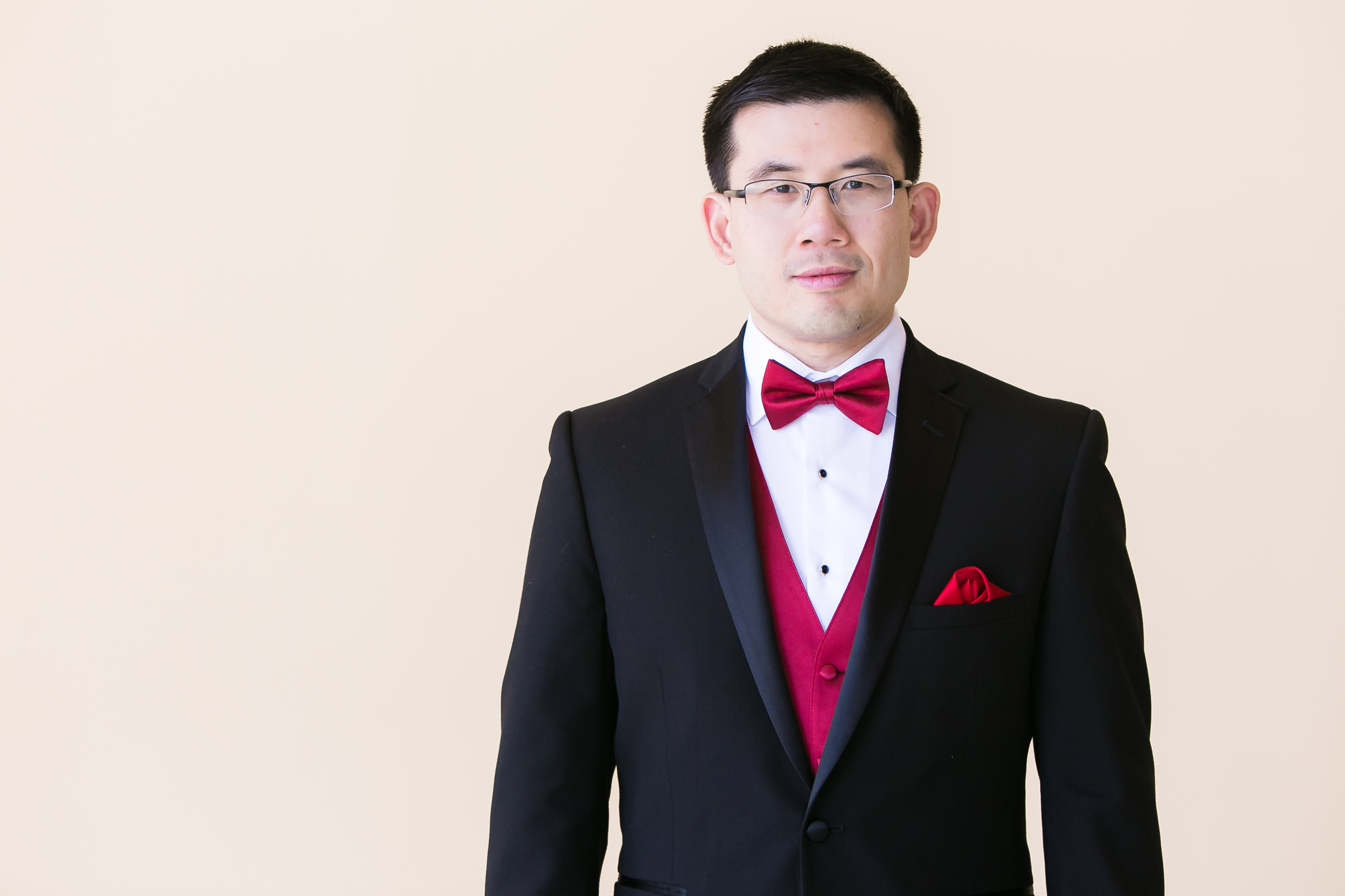Half body portrait of asian groom in tuxedo