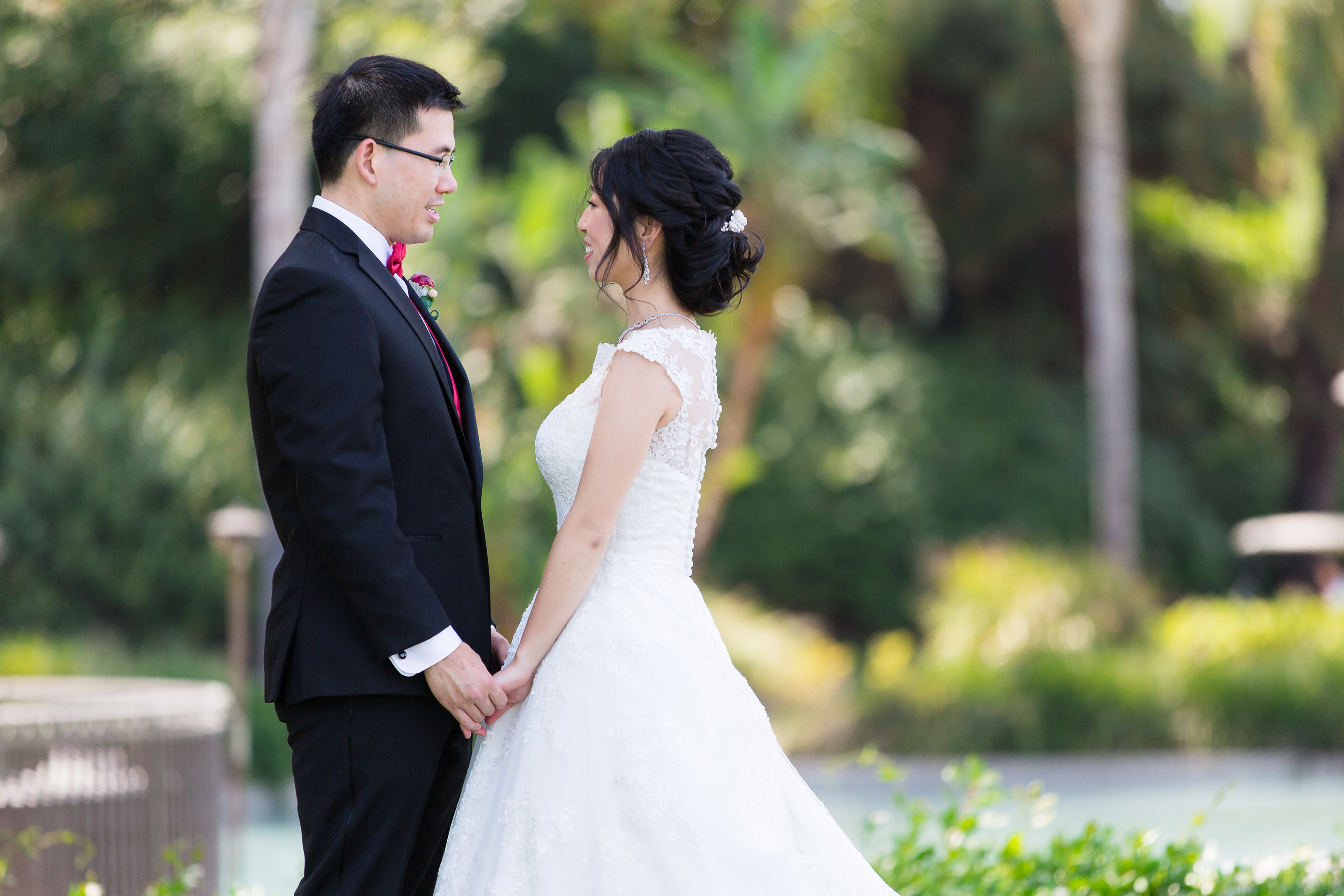 Asian couple holding hands and looking at eachother