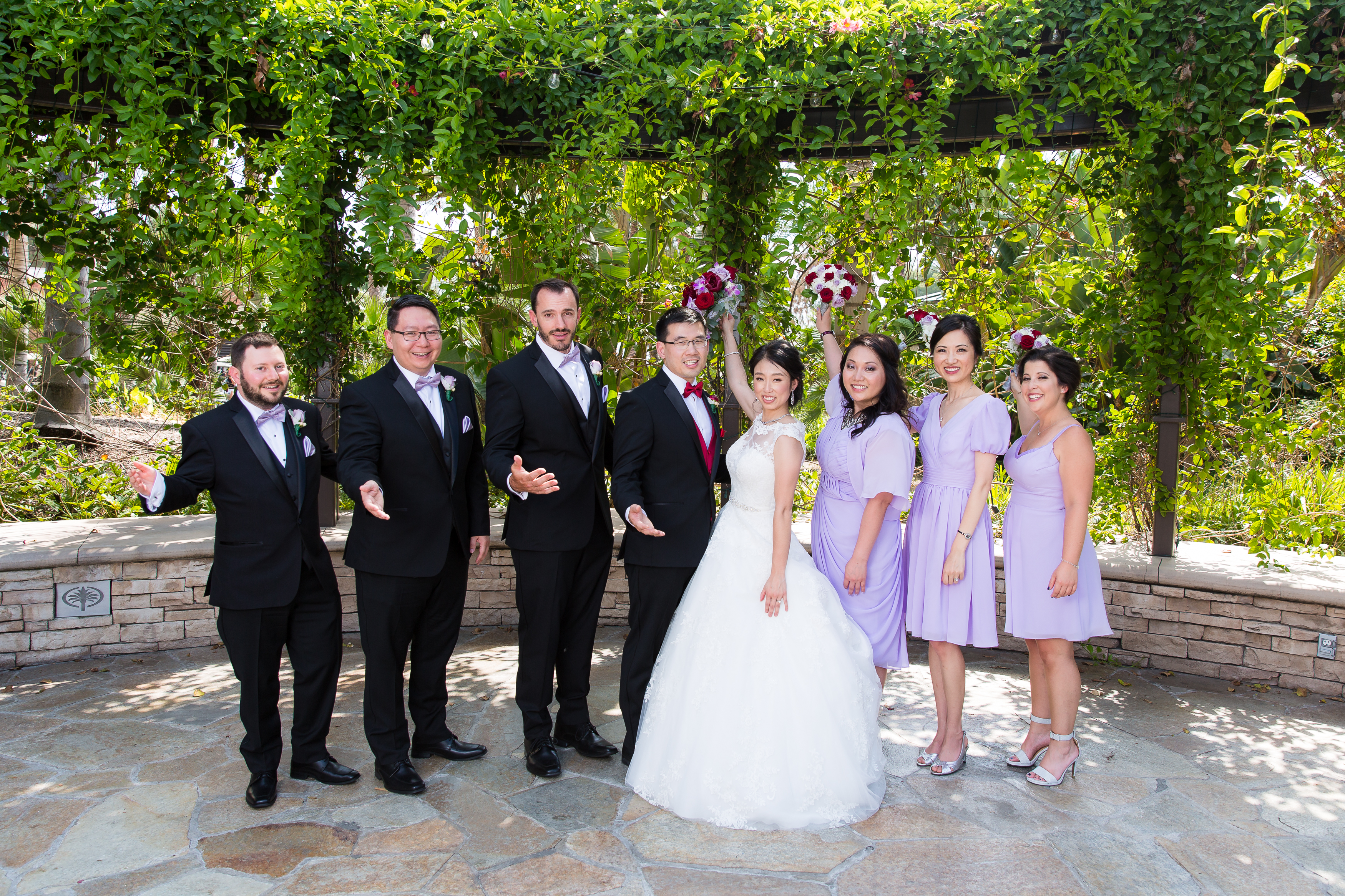 Bridesmaids and groomsmen celebrating couple's marriage
