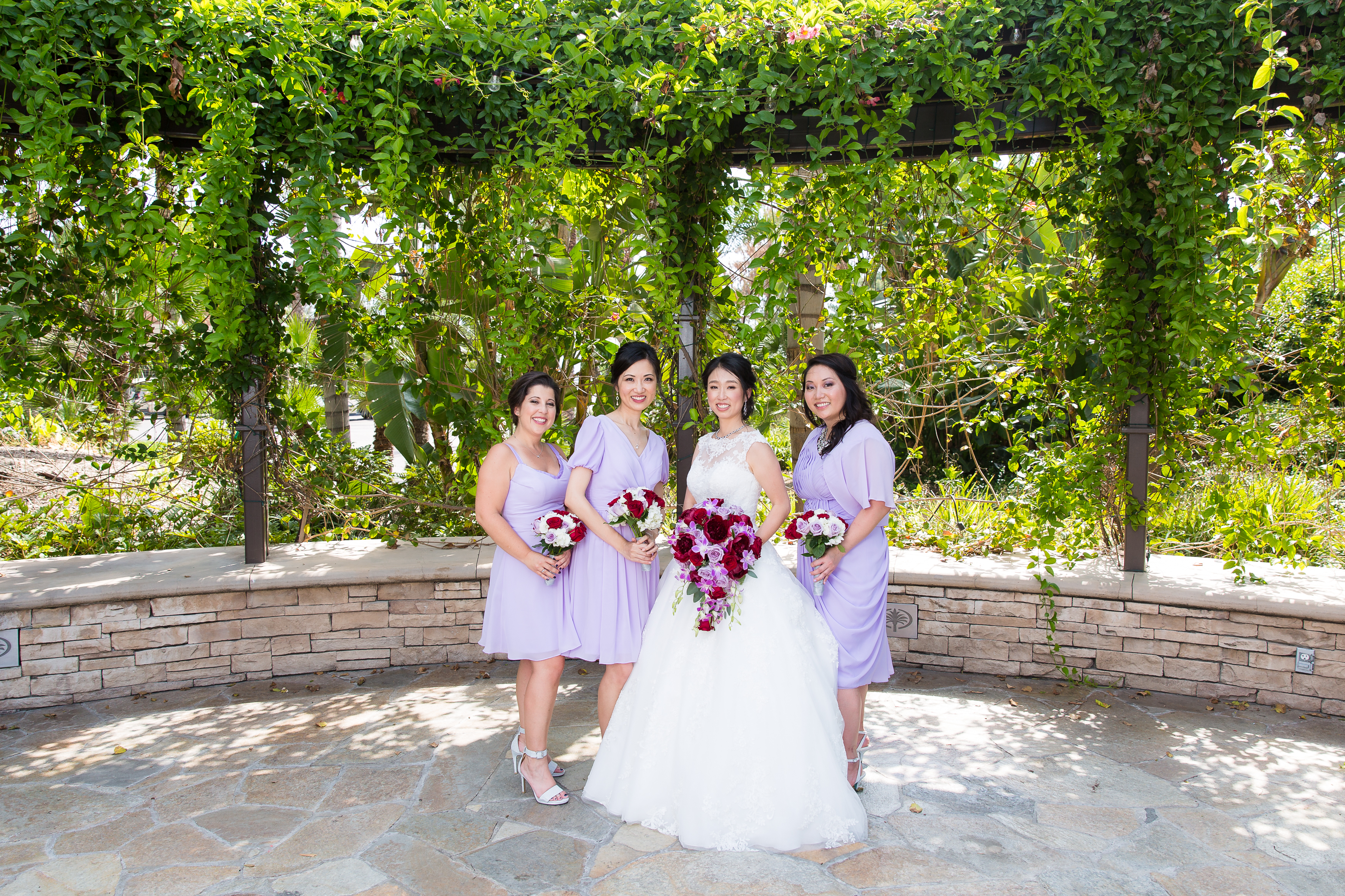Bride smiling with bridesmaids in purple dresses