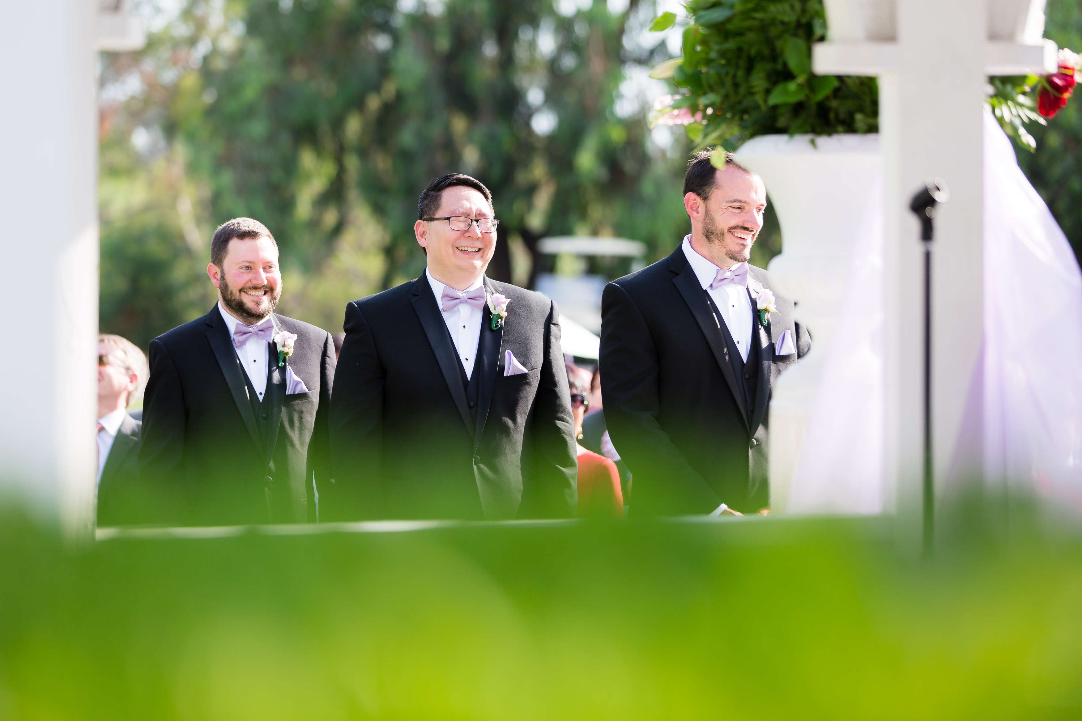 Groomsmen laughing during wedding ceremony