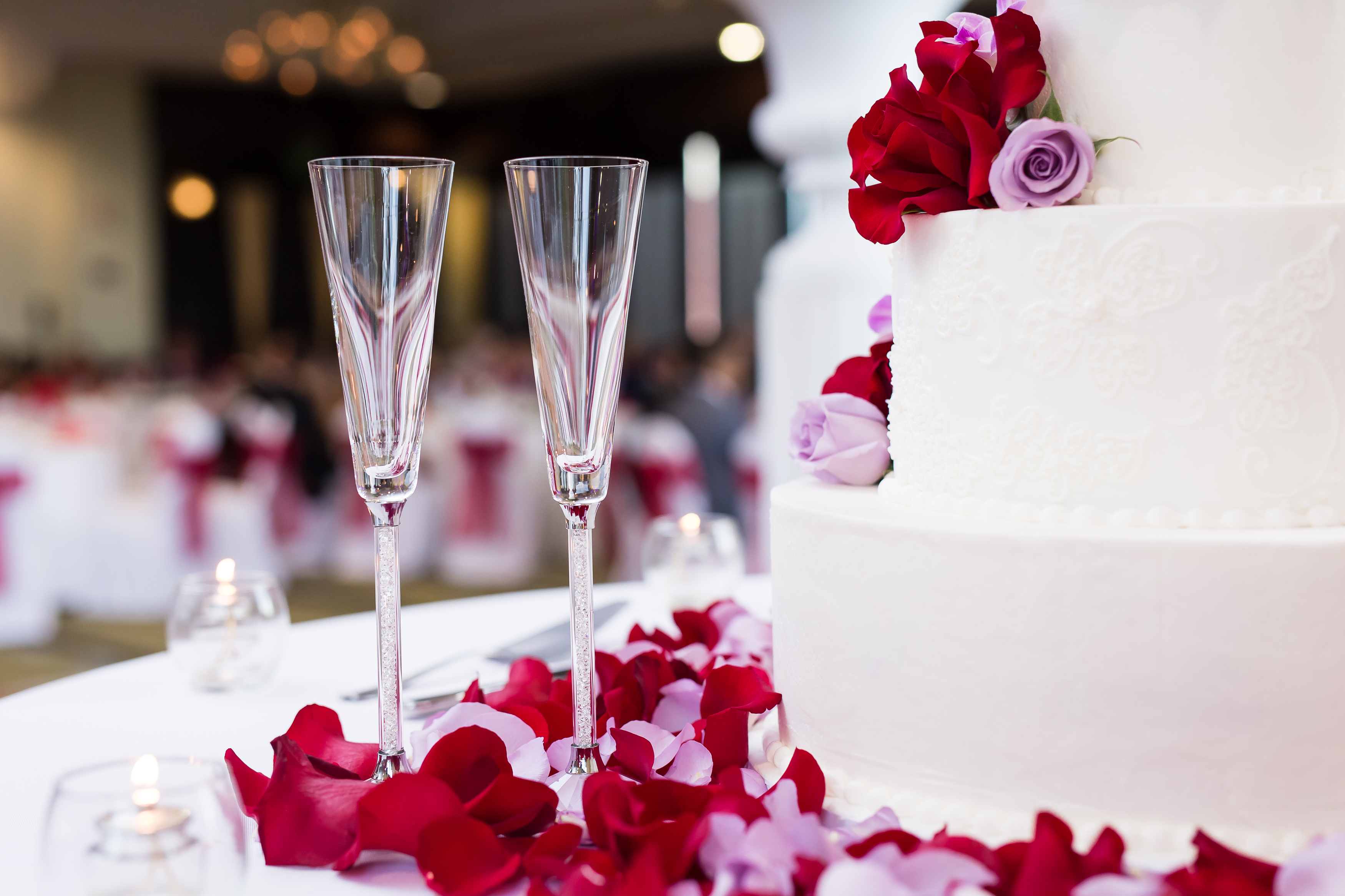 Champagne flutes next to wedding cake