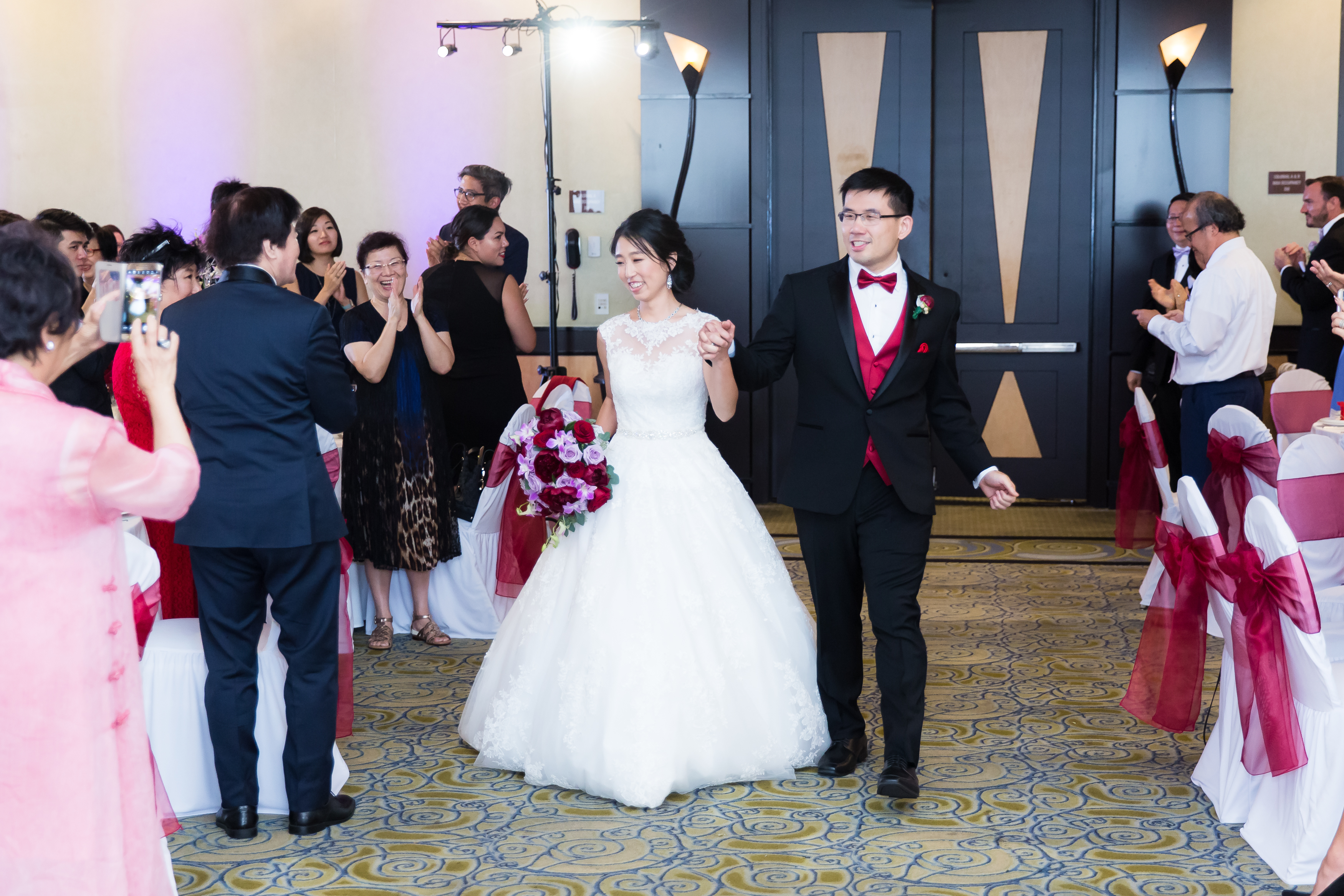 Bride and groom entering reception for grand entrance