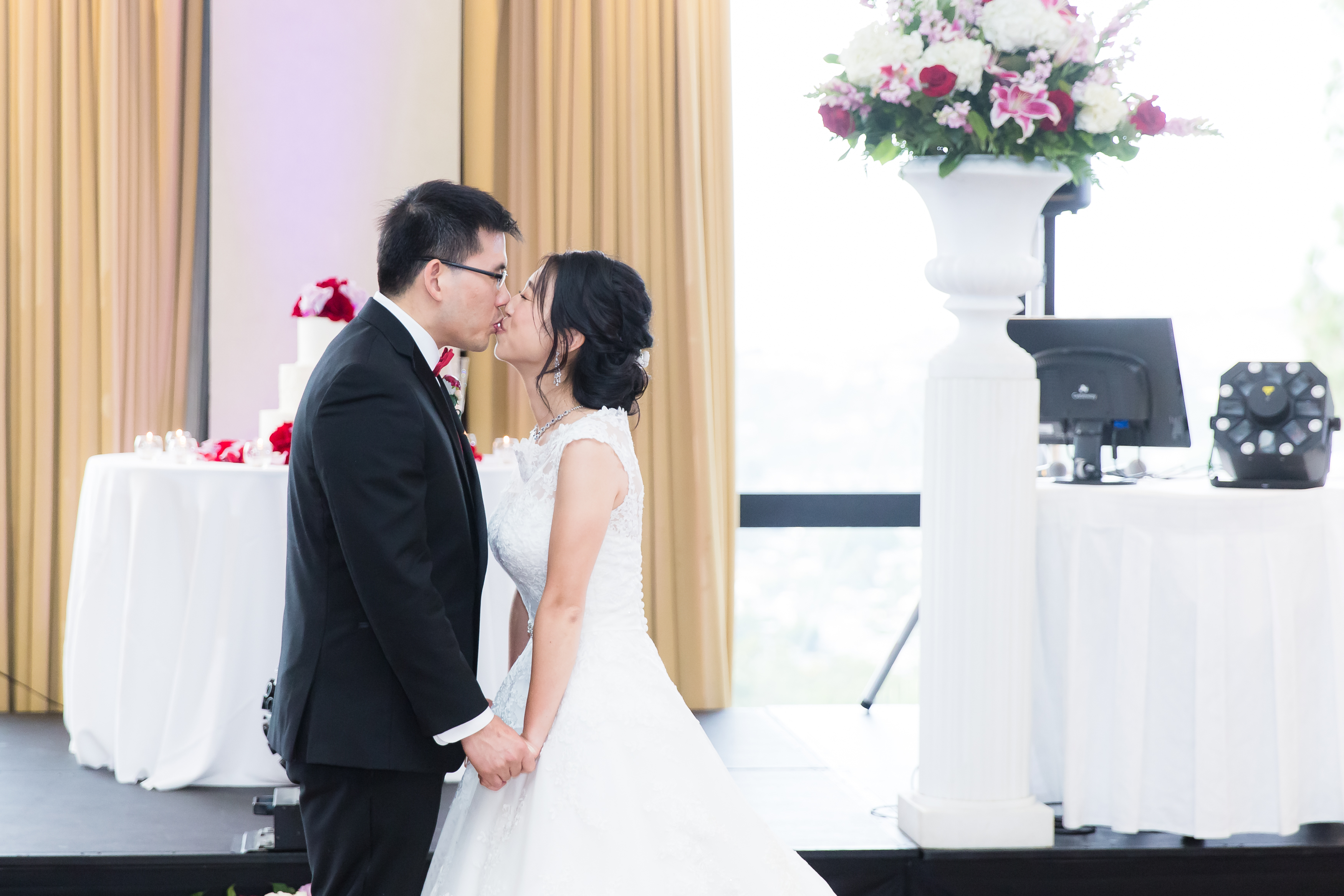 Husband and wife kiss after first dance during wedding reception