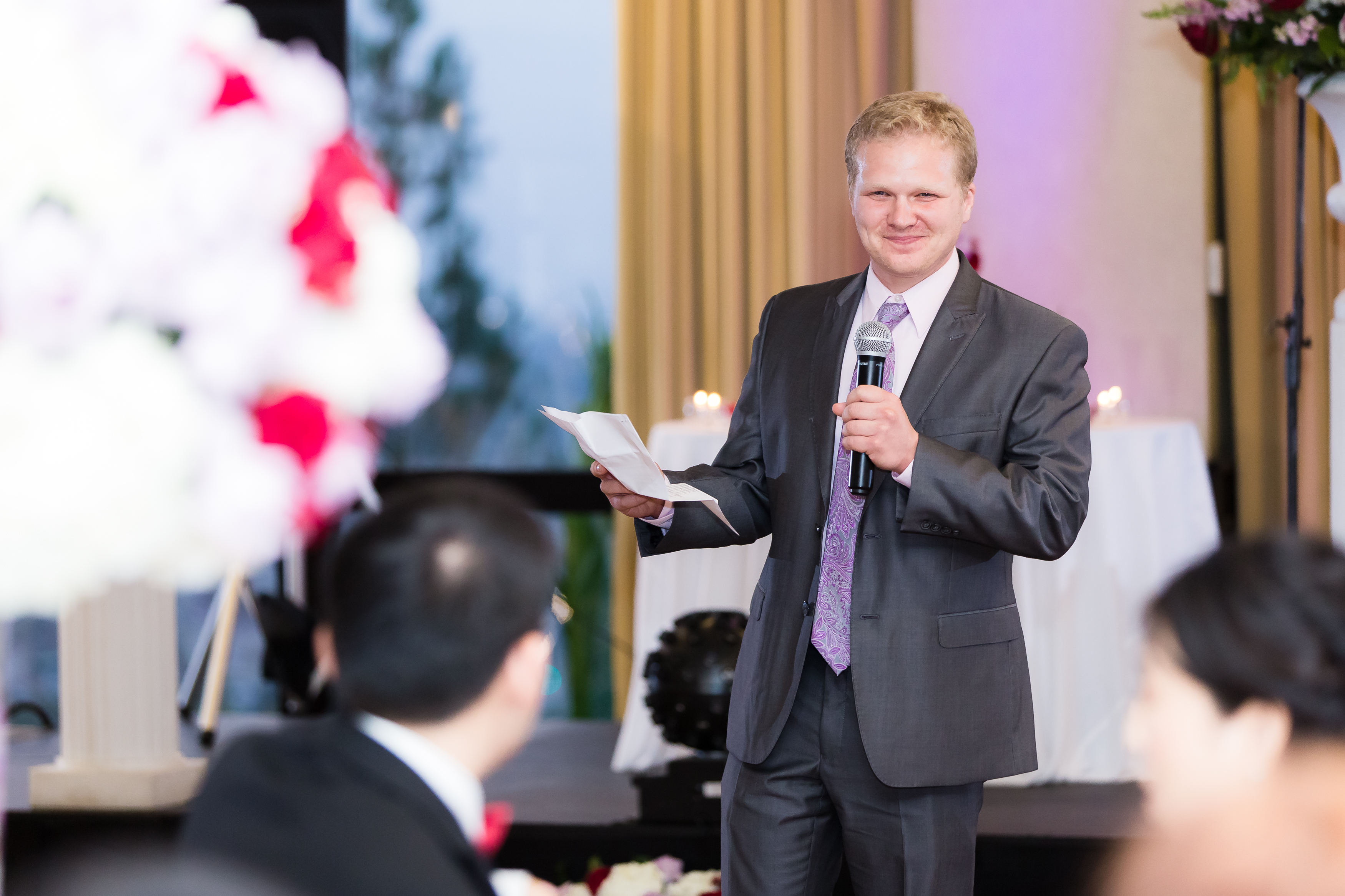 Groomsmen delivering speech during wedding reception
