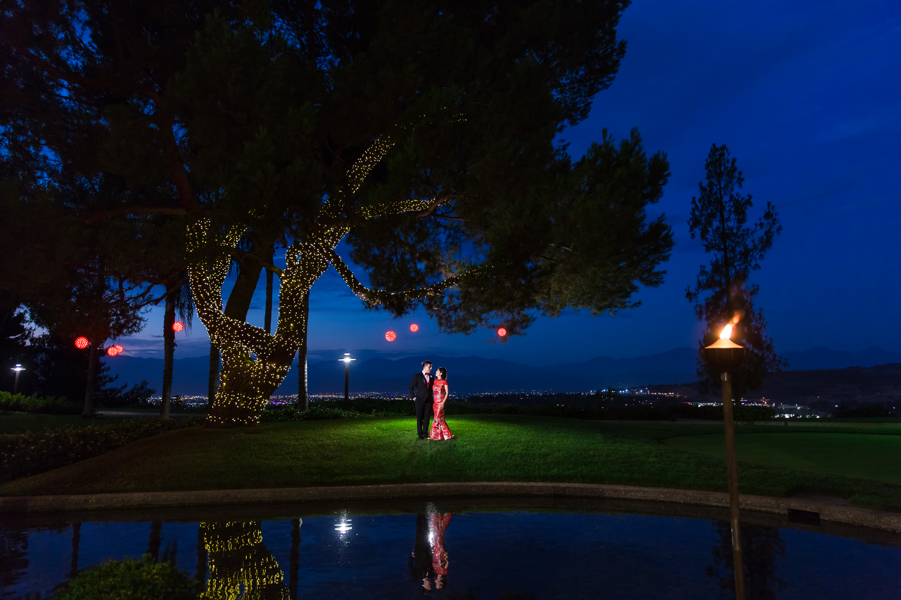 Asian bride and groom under tree during sunset at Pacific Palms Resort Wedding