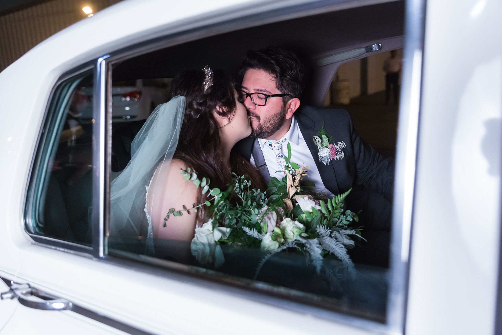 Hangar 21 wedding couple kissing in vintage car