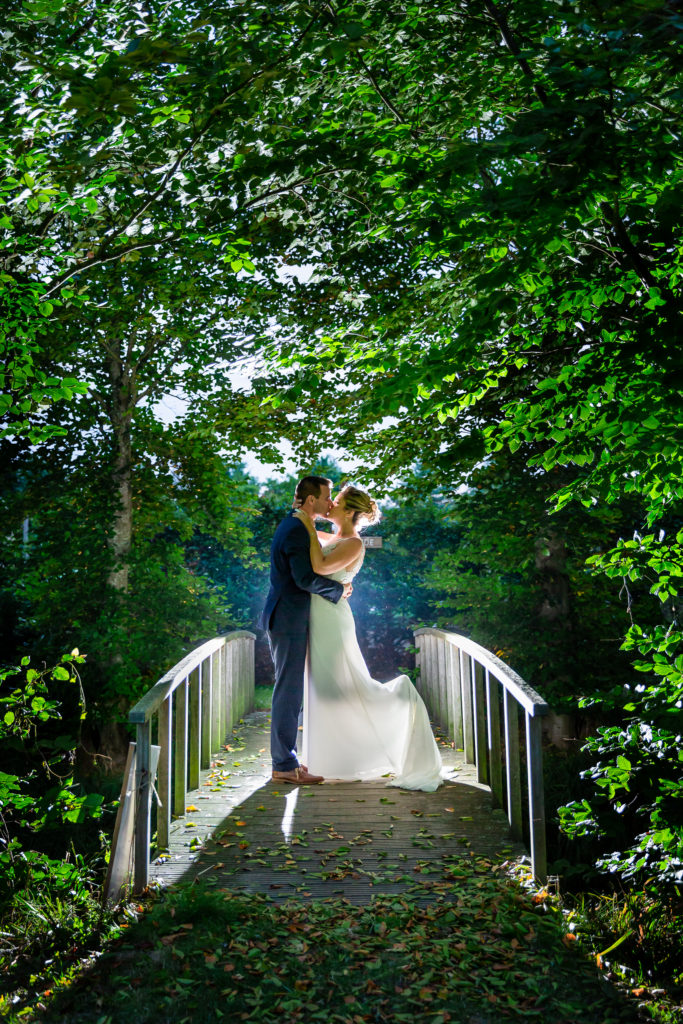 Wedding couple standing on bridge at Belgium Garden Wedding