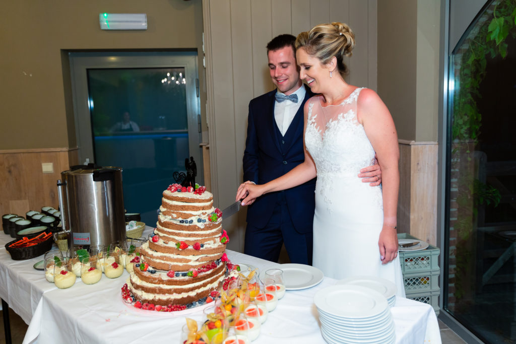 Bride and groom cutting their cake at Belgium Garden Wedding