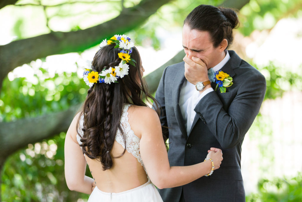 Emotional groom during first look wedding photo session