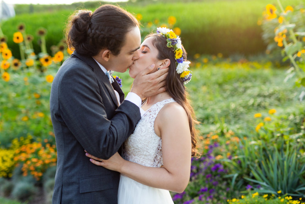 Phipps Conservatory Wedding bride and groom kissing among sunflowers
