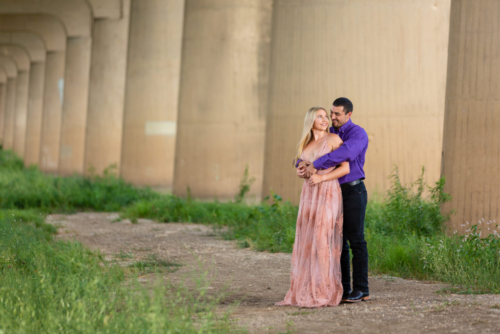 Man holding fiancee during photo session