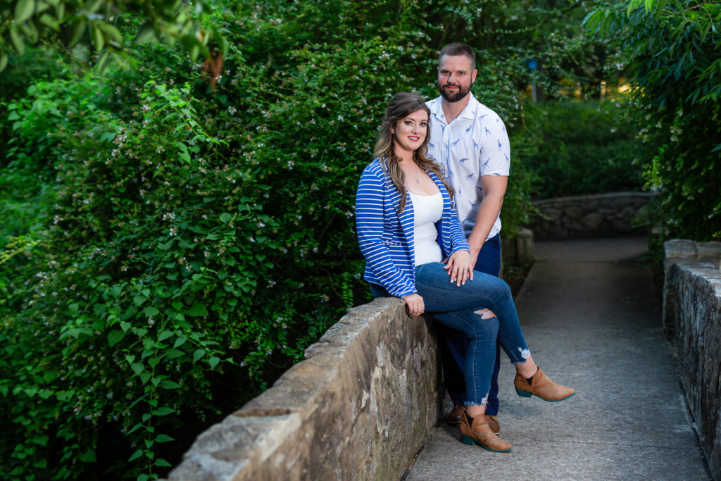 Couple posing on stone bridge in Dallas