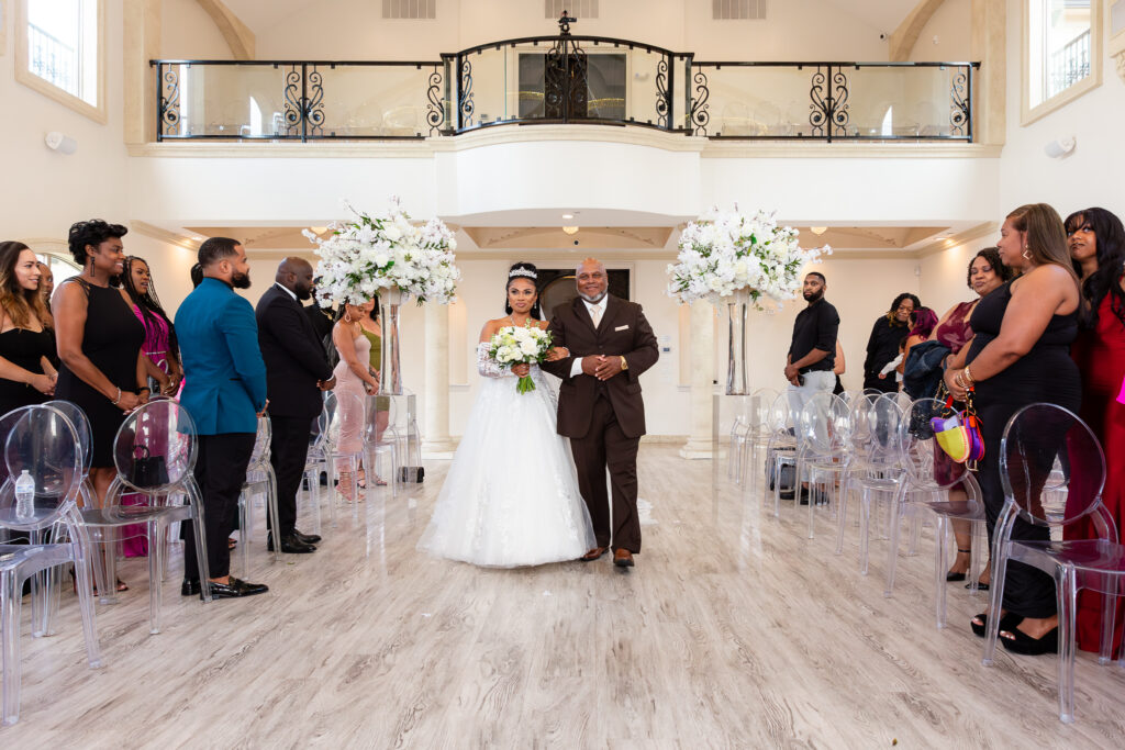 dad walks bride down aisle in cathedral room at knotting hill place wedding venue in little elm texas