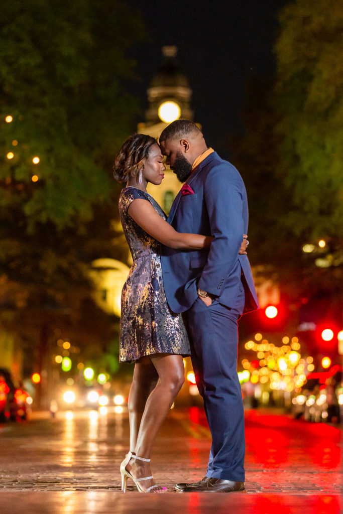 Intimate couple forehead to forehead during nighttime Fort Worth engagement session in Sundance Square Fort Worth Texas