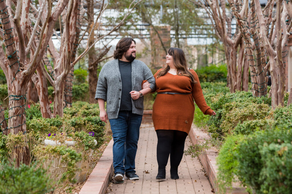 Clark Gardens engagement session photographed by dallas wedding photographer with man and woman walking on a path together in a park during the fall