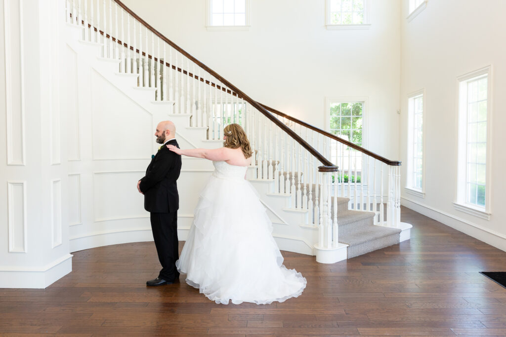 Dallas wedding photographers capture first look in grand entryway at Milestone Denton wedding venue