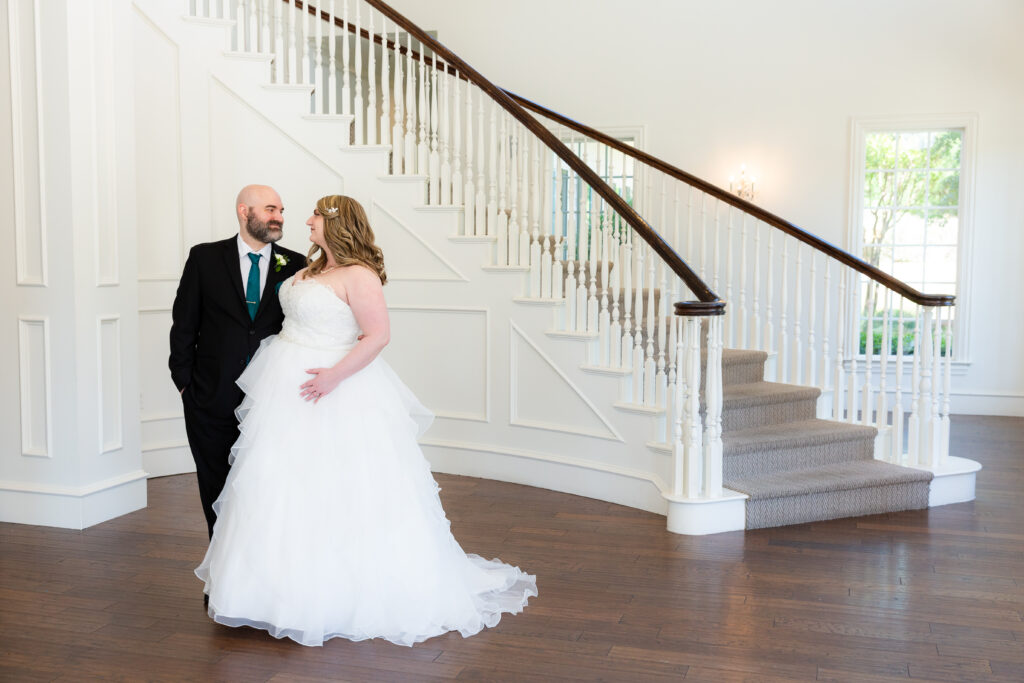 Dallas wedding photographers capture couple standing near staircase at The Milestone Denton