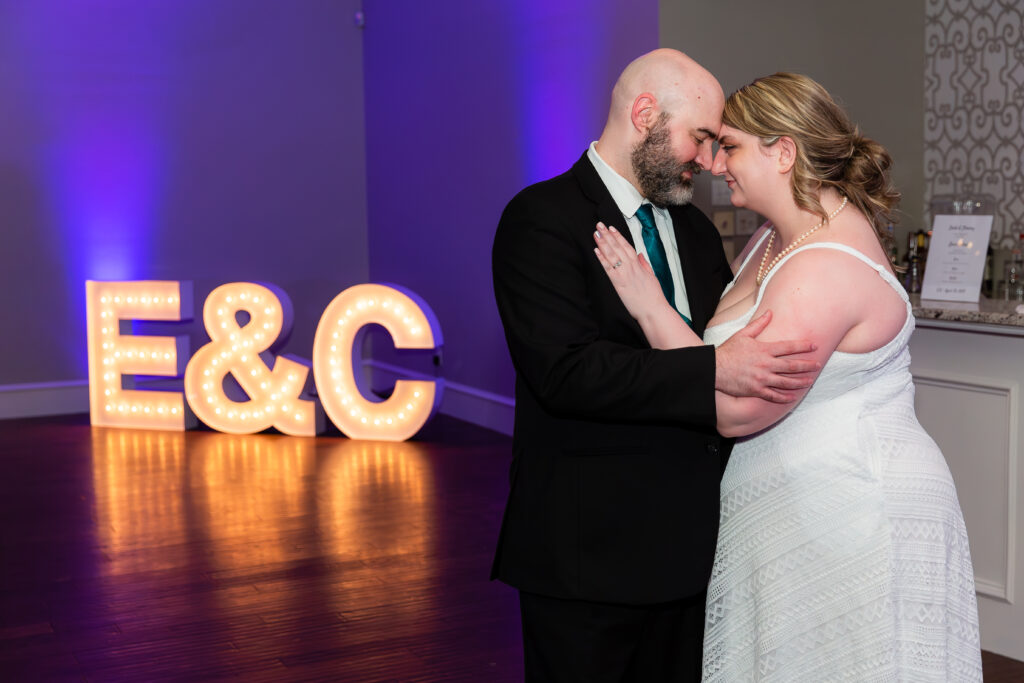Dallas wedding photographers capture couple embracing at end of wedding reception