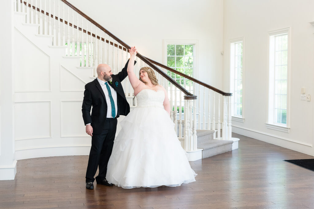 Groom spinning bride in wedding dress at Milestone Denton wedding venue in North Texas