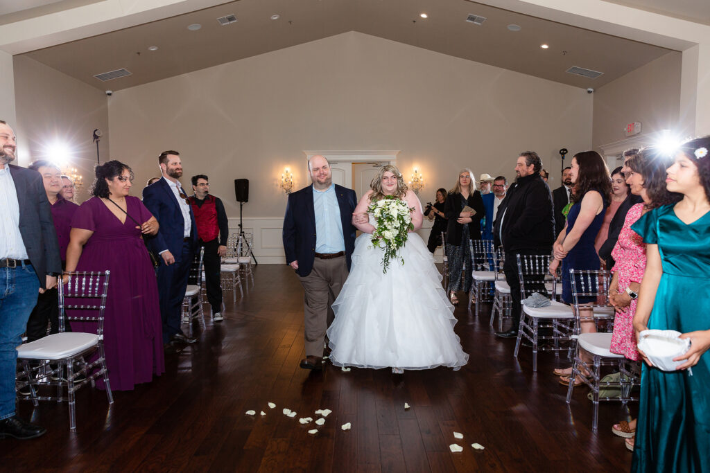 Bride excitedly walking down aisle in chapel at milestone denton wedding venue