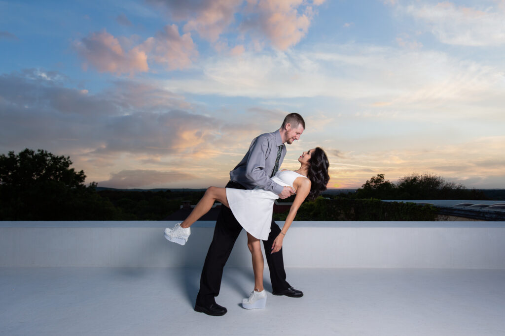 Dallas wedding photographers capture man dipping woman on rooftop