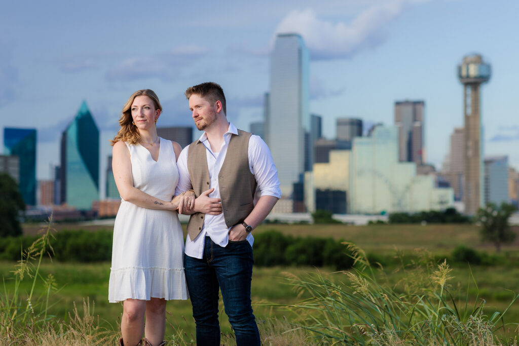 Dallas wedding photographers capture man looking at fiancee during outdoor Dallas engagement