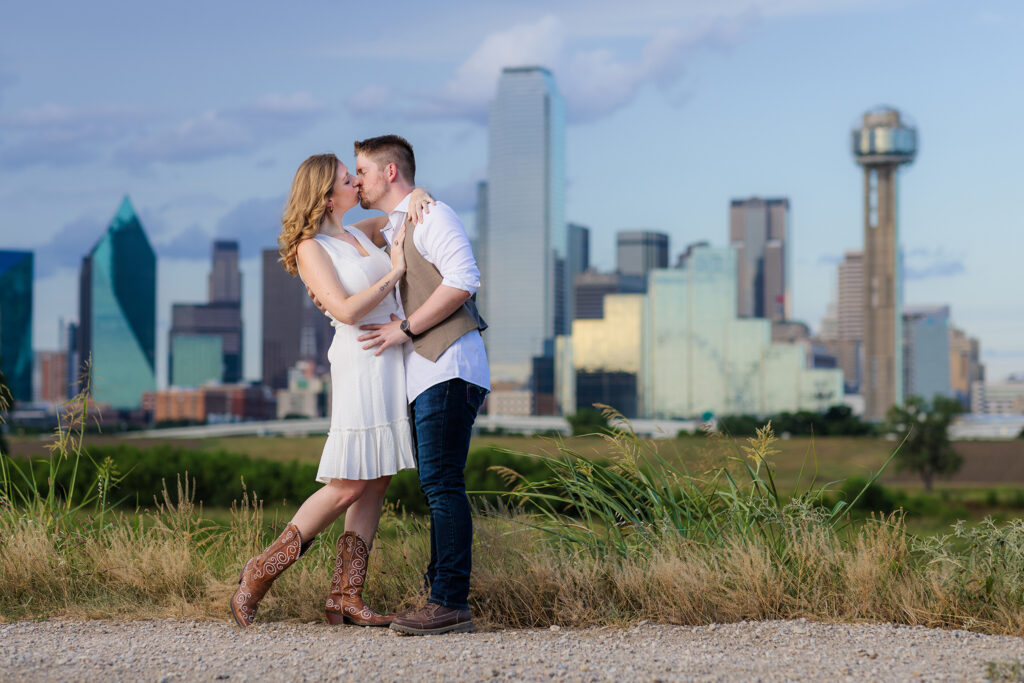 Engaged couple hugging and dipping while smiling at Trinity Overlook Park during engagement session by Dallas wedding photographer Stefani Ciotti Photography
