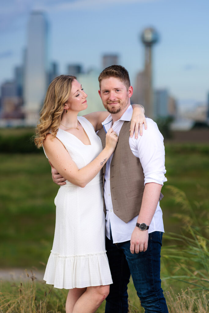 Dallas wedding photographers capture woman hugging fiance and looking over lovingly