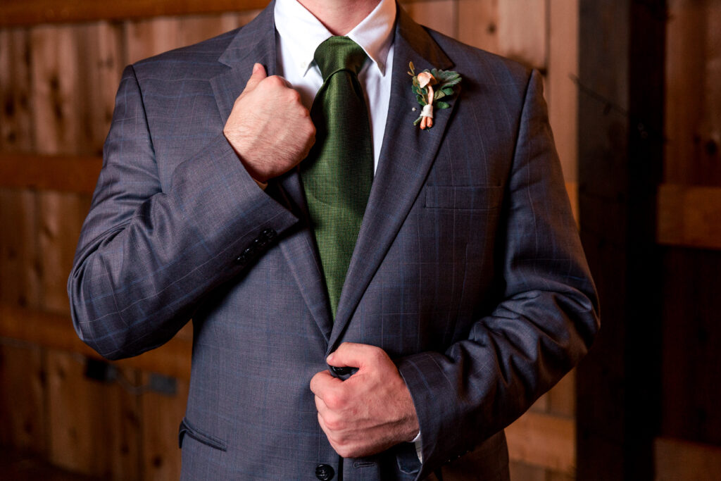 Dallas wedding photographers capture groom holding jacket