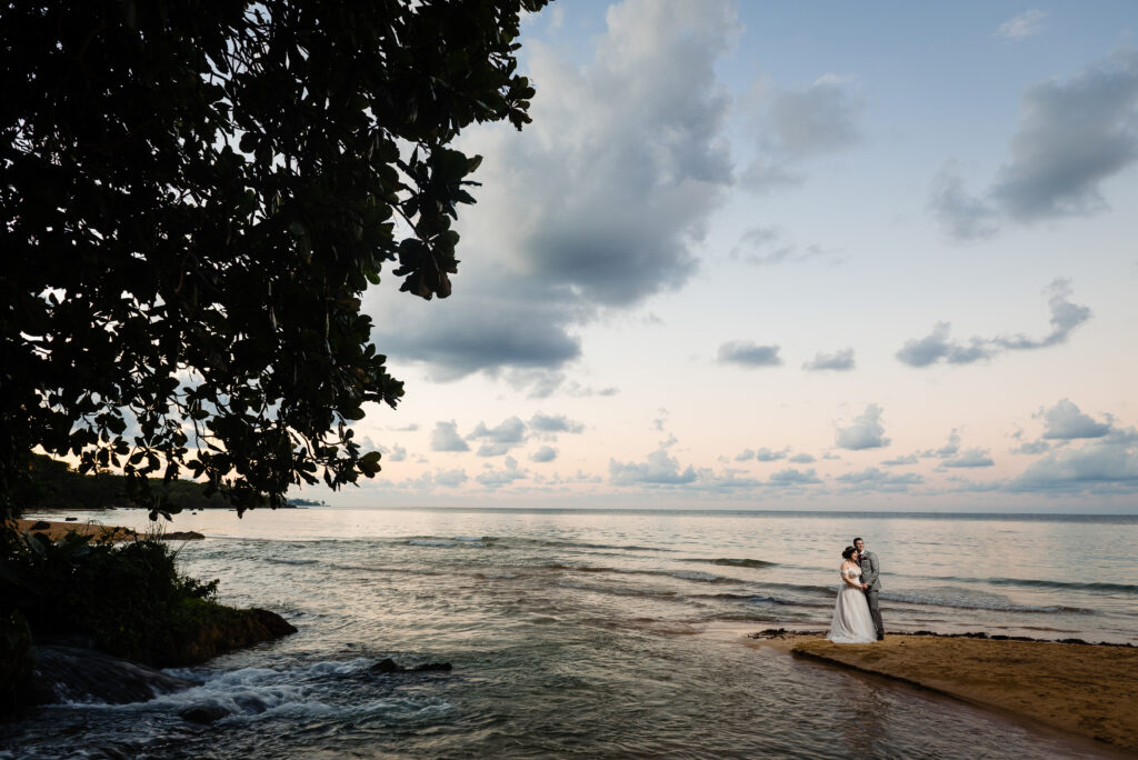 Bride and groom on beach at sunset during Jamaican beach destination wedding