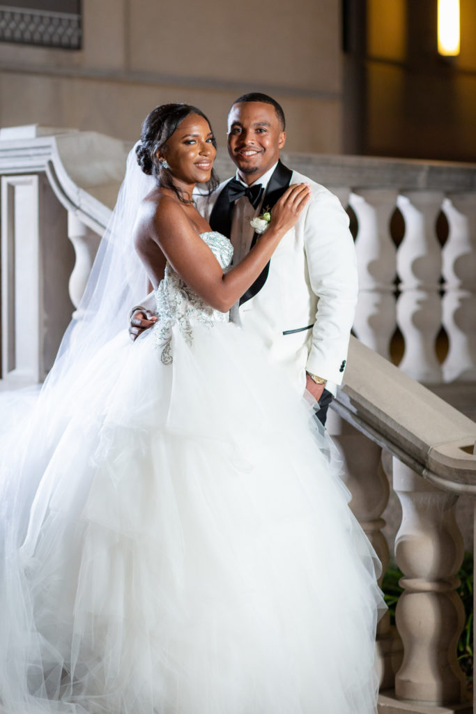Bride and groom on staircase at Hotel Crescent Court for their indoor bridal session with Dallas wedding photographers