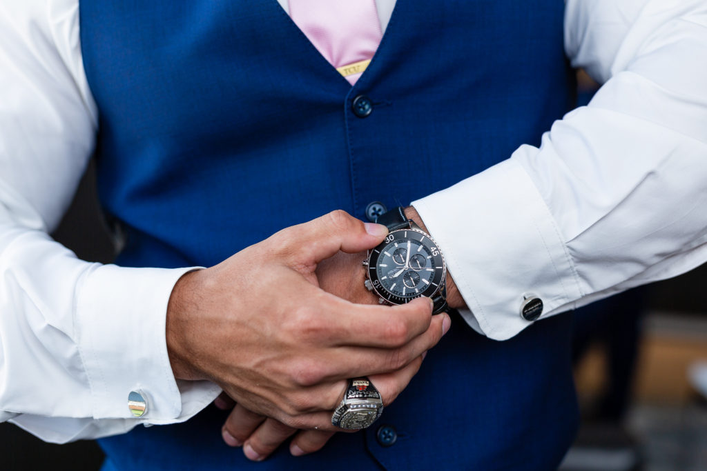 Groom checking the time on his watch